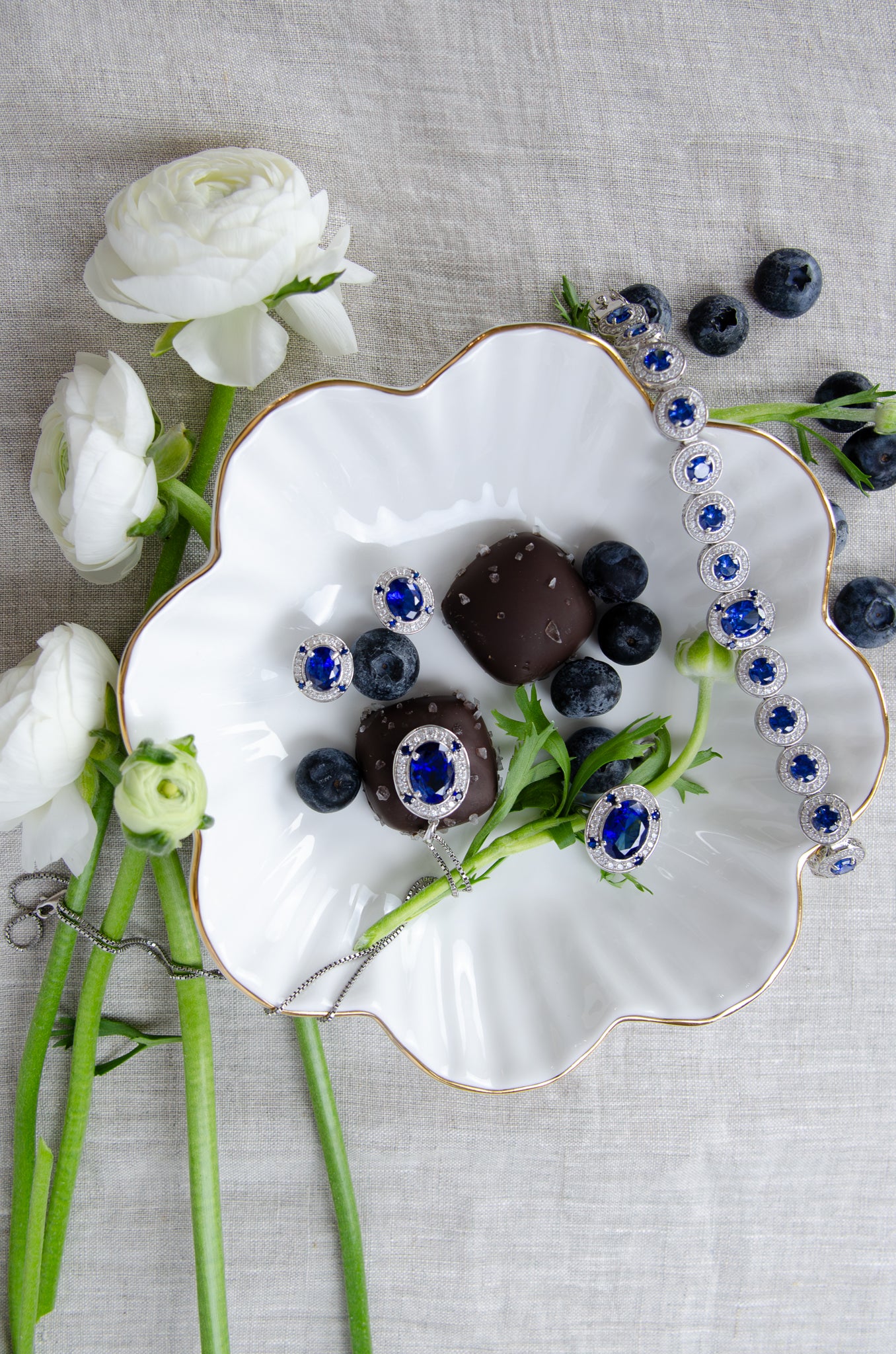 Styled group photo showcasing the complete Diana Legacy Collection, blending sapphire gemstones, and sterling silver to celebrate love, legacy, and light, Ether Jewelry