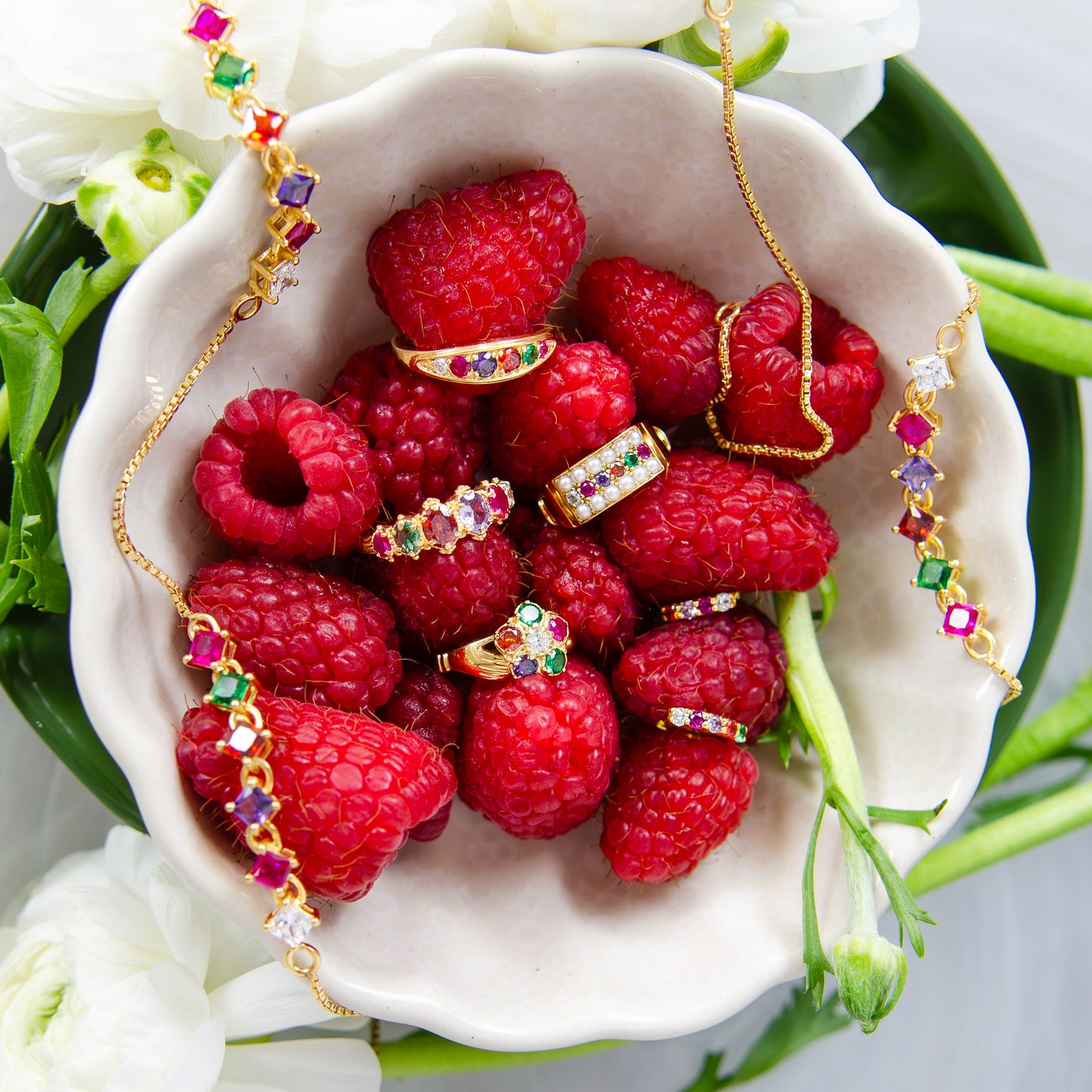 Regard Bloom Ring in 18k gold vermeil styled in bowl of raspberries with full Regard collection, acrostic floral cluster ring, Ether Jewelry
