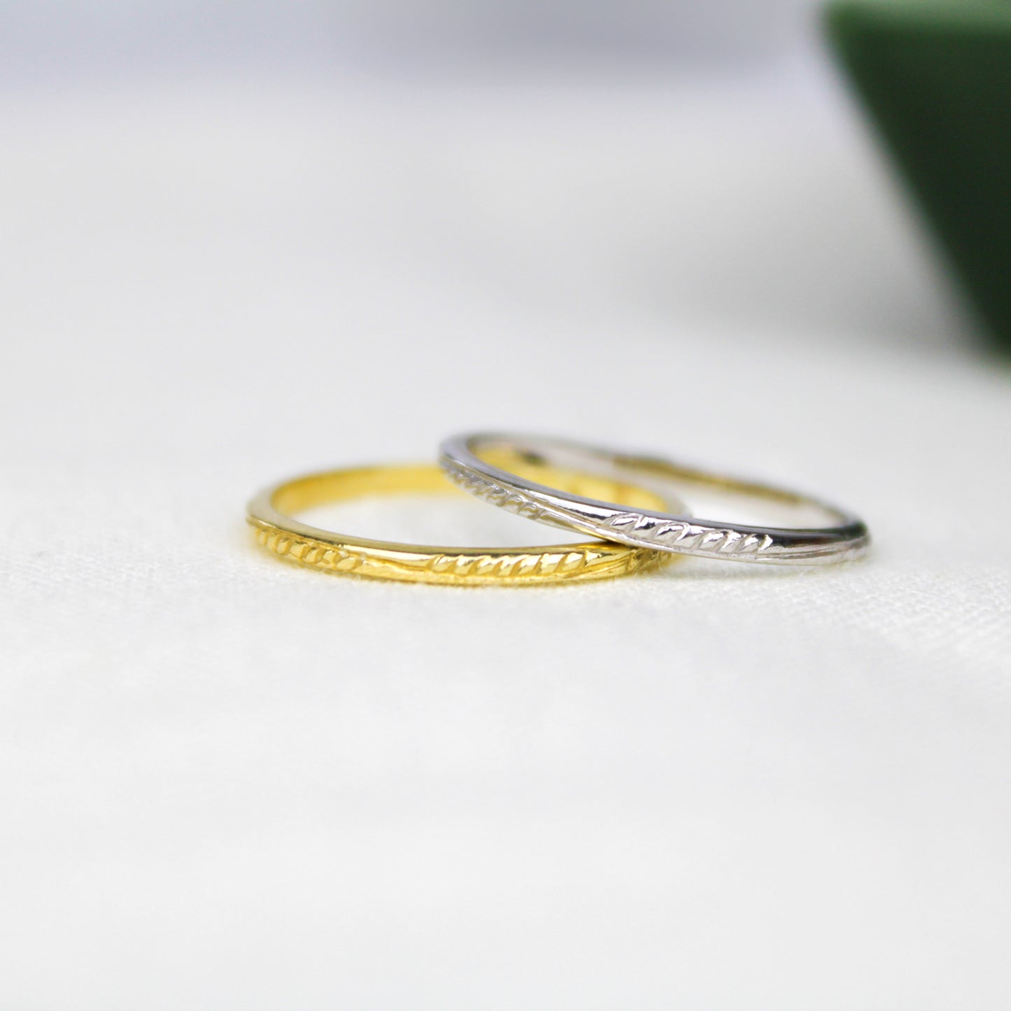 Victorian Vine Stacker sterling silver and gold vermeil engraved stacking rings laid on top of each other, Ether Jewelry