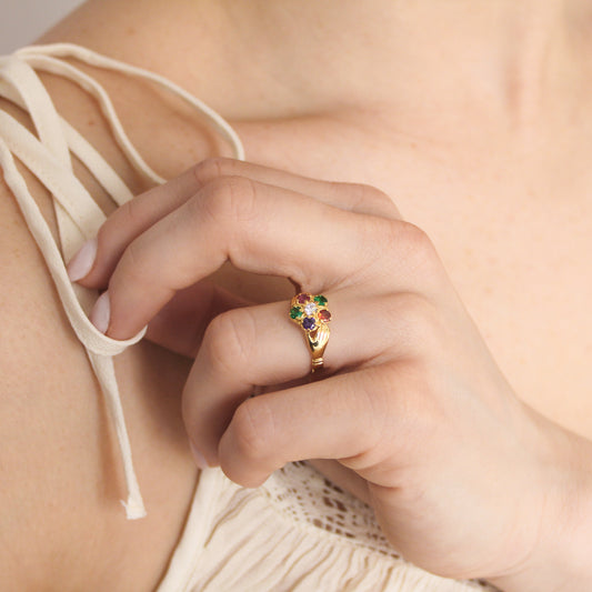 Regard Bloom Ring in 18k gold vermeil worn on model hand on chest in beige dress, floral REGARD acrostic cluster ring, Ether Jewelry
