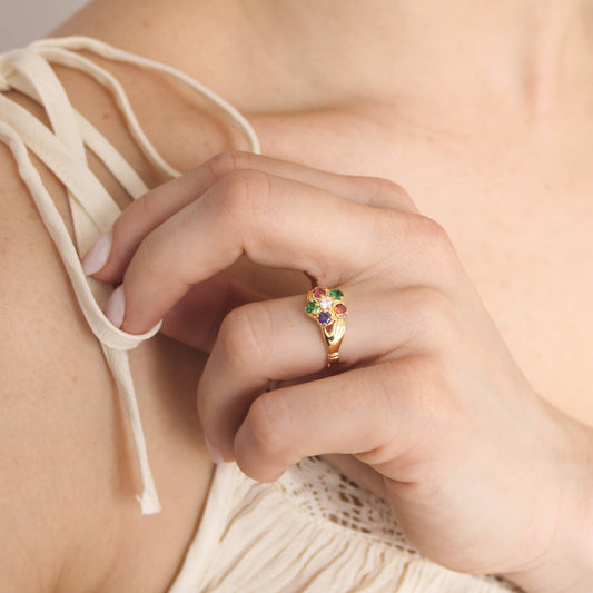Regard Bloom Ring in 18k gold vermeil worn on model hand on chest in beige dress, floral REGARD acrostic cluster ring, Ether Jewelry