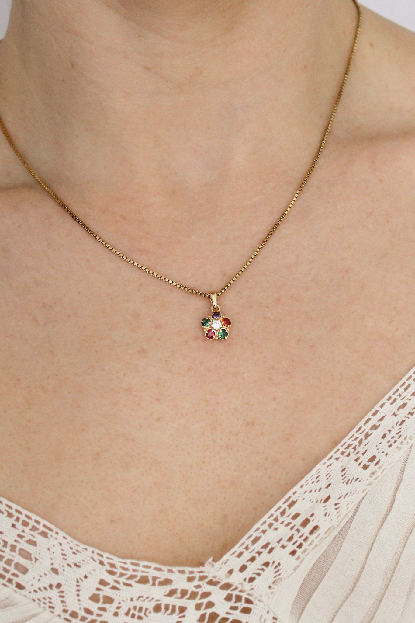 18k gold vermeil Regard Bloom Necklace front view on model, colorful REGARD acrostic floral pendant on box chain, Ether Jewelry