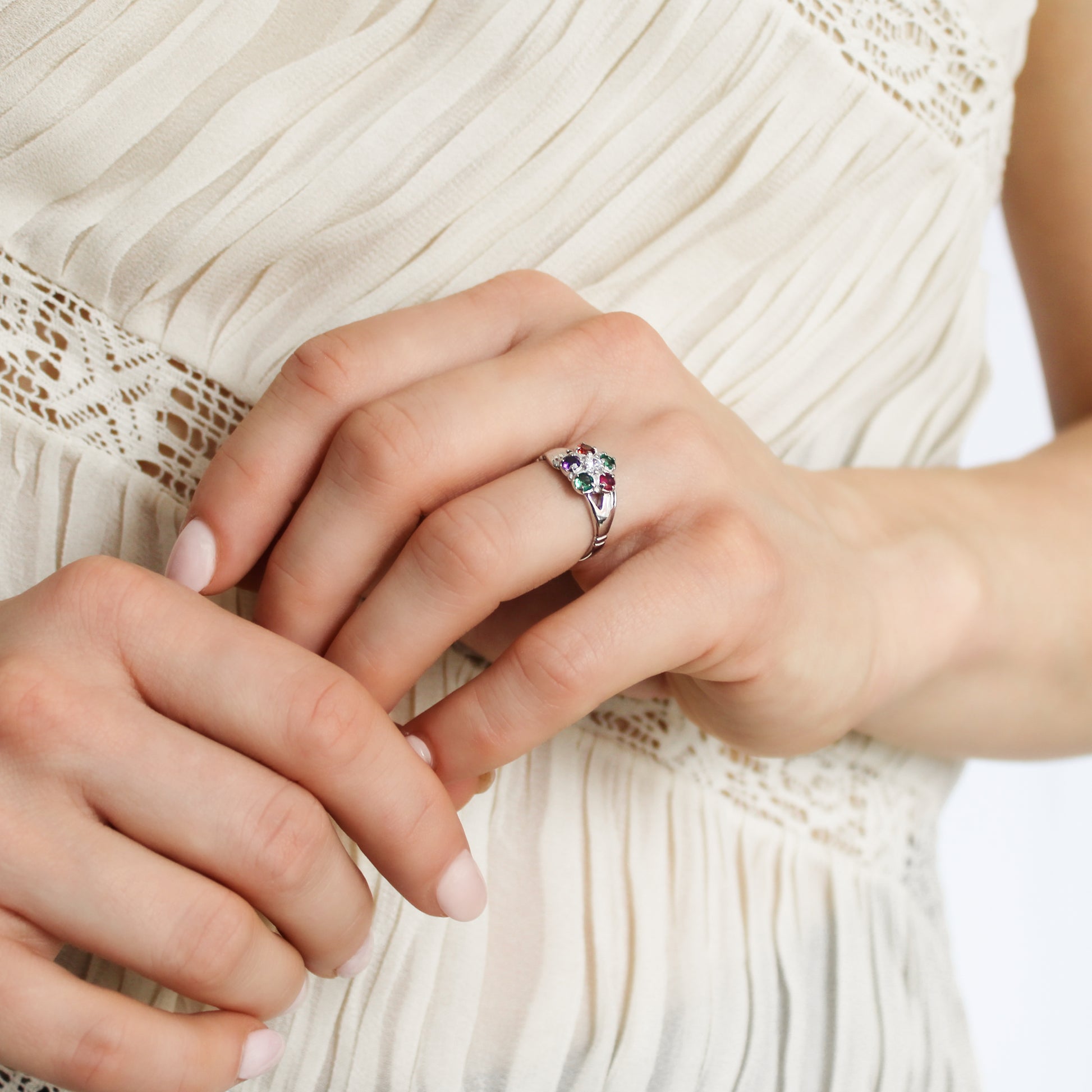 Regard Bloom Ring sterling silver on model holding hand wearing ring, REGARD acrostic floral jewelry, Ether Jewelry