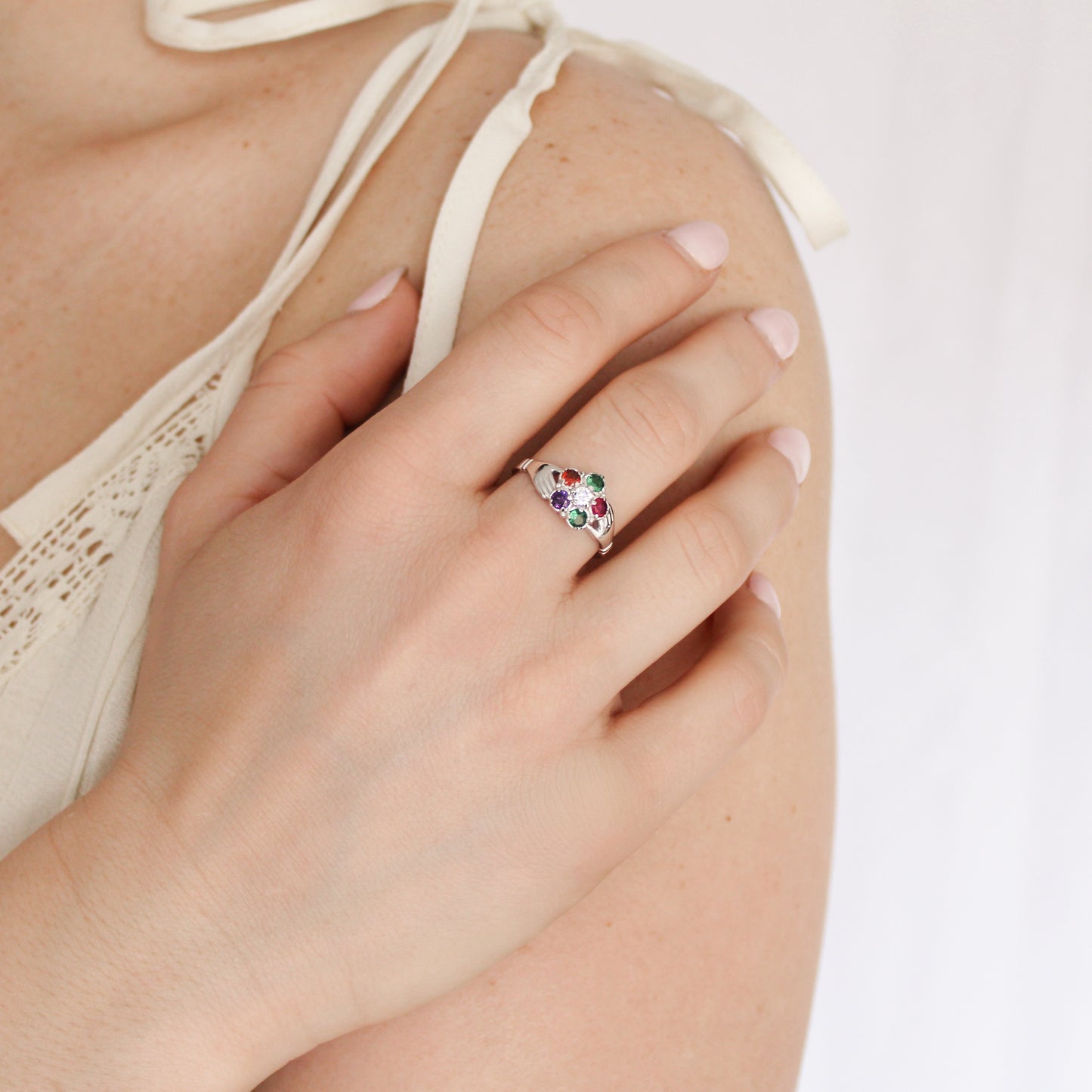 Sterling silver Regard Bloom Ring on model holding up hand, colorful acrostic gemstone floral cluster ring, Ether Jewelry