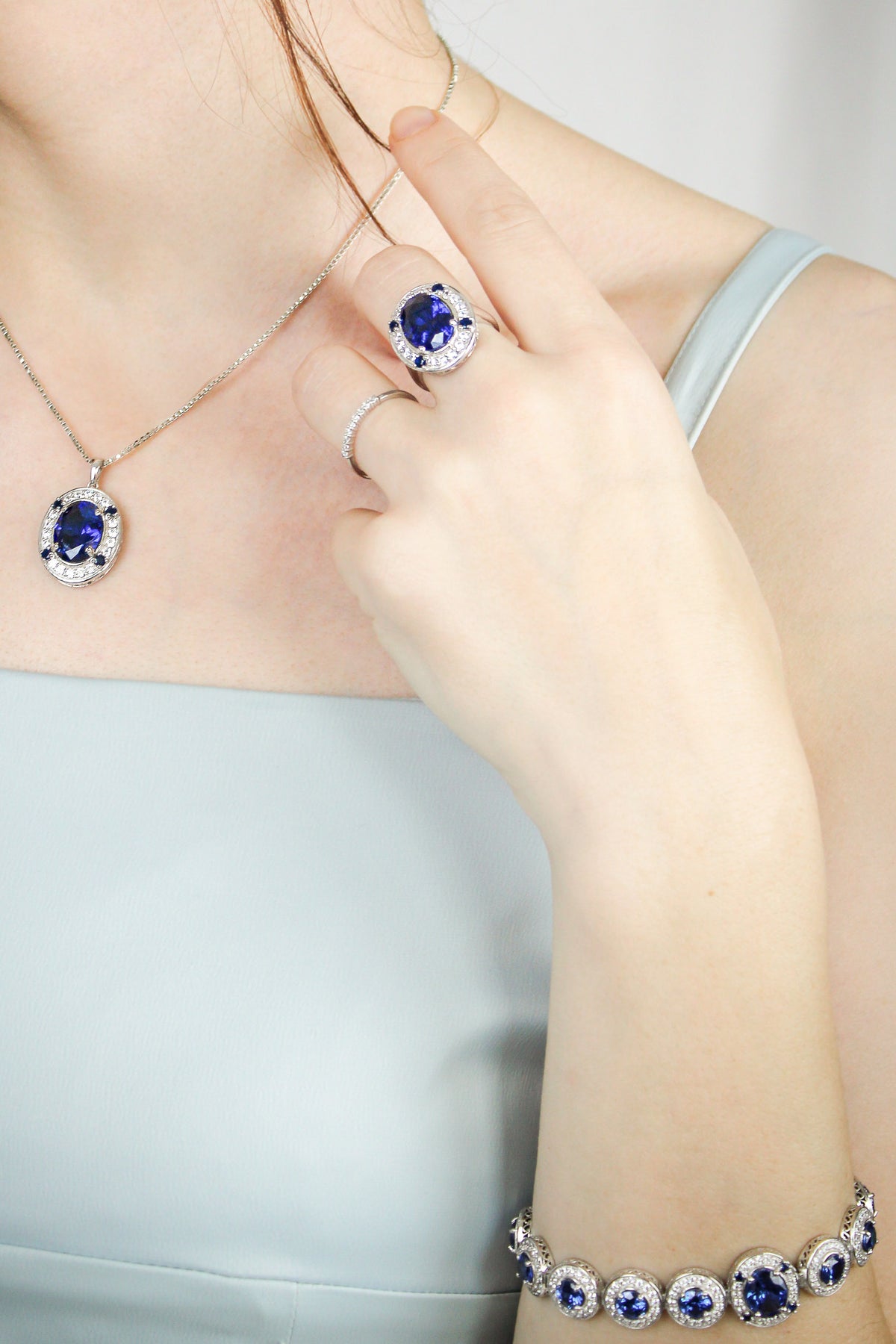 Diana Legacy Jewelry set with necklace, ring, and bracelet featuring blue gemstones on a neutral background, Ether Jewelry