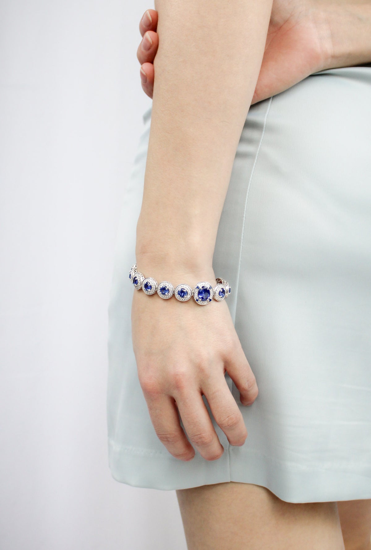 Model wearing silver Halo Bracelet with sapphire-toned gemstones — inspired by Princess Diana’s enduring legacy, Ether Jewelry