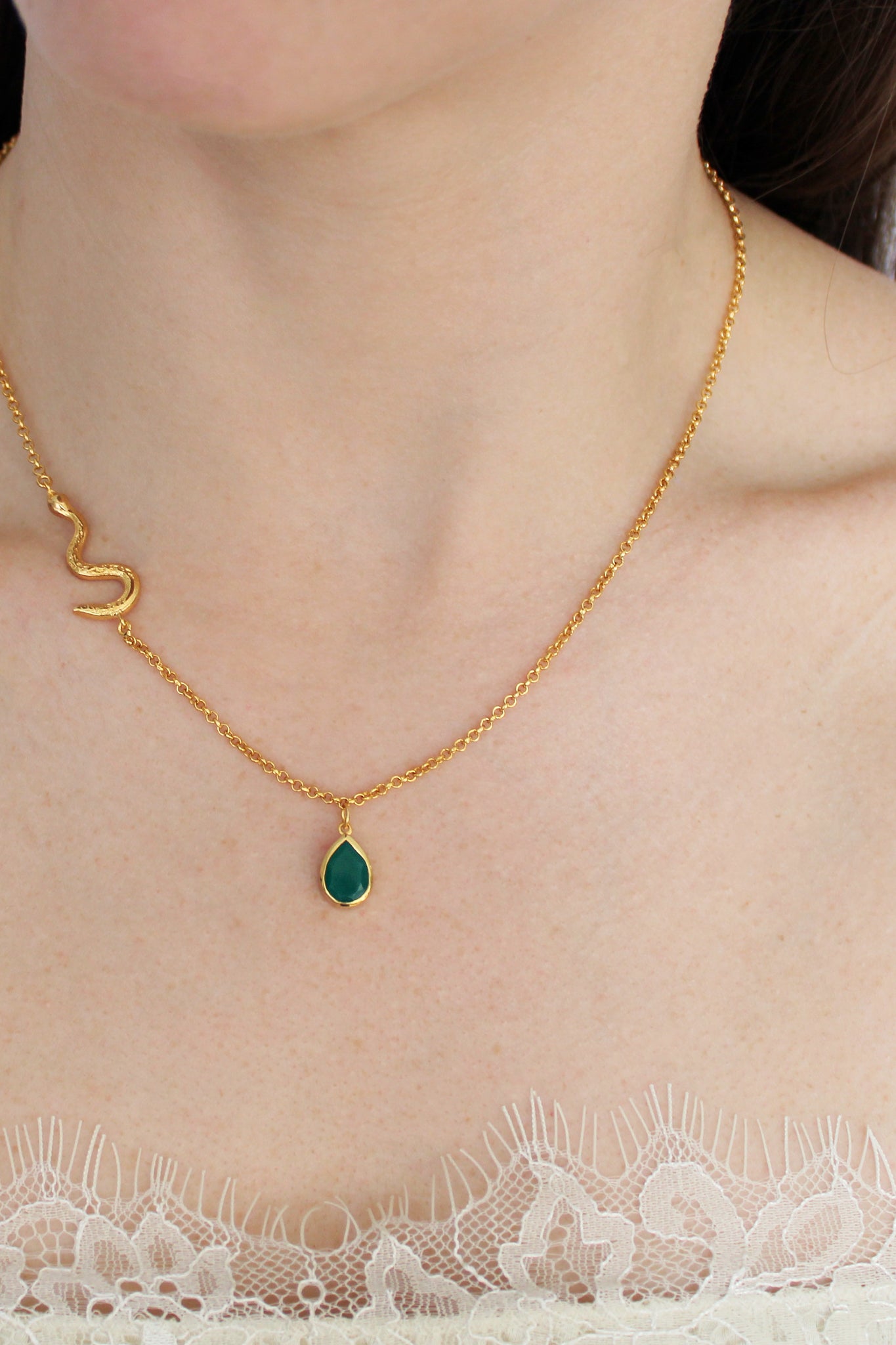 Devoted Necklace in 18k gold vermeil worn on model, asymmetric serpent chain with green onyx teardrop pendant, front view, Ether Jewelry