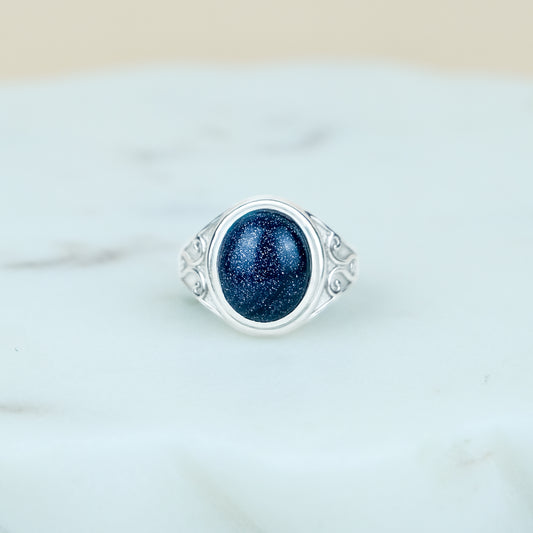 sterling Silver night keeper signet ring with a blue sandstone gemstone on a marble background