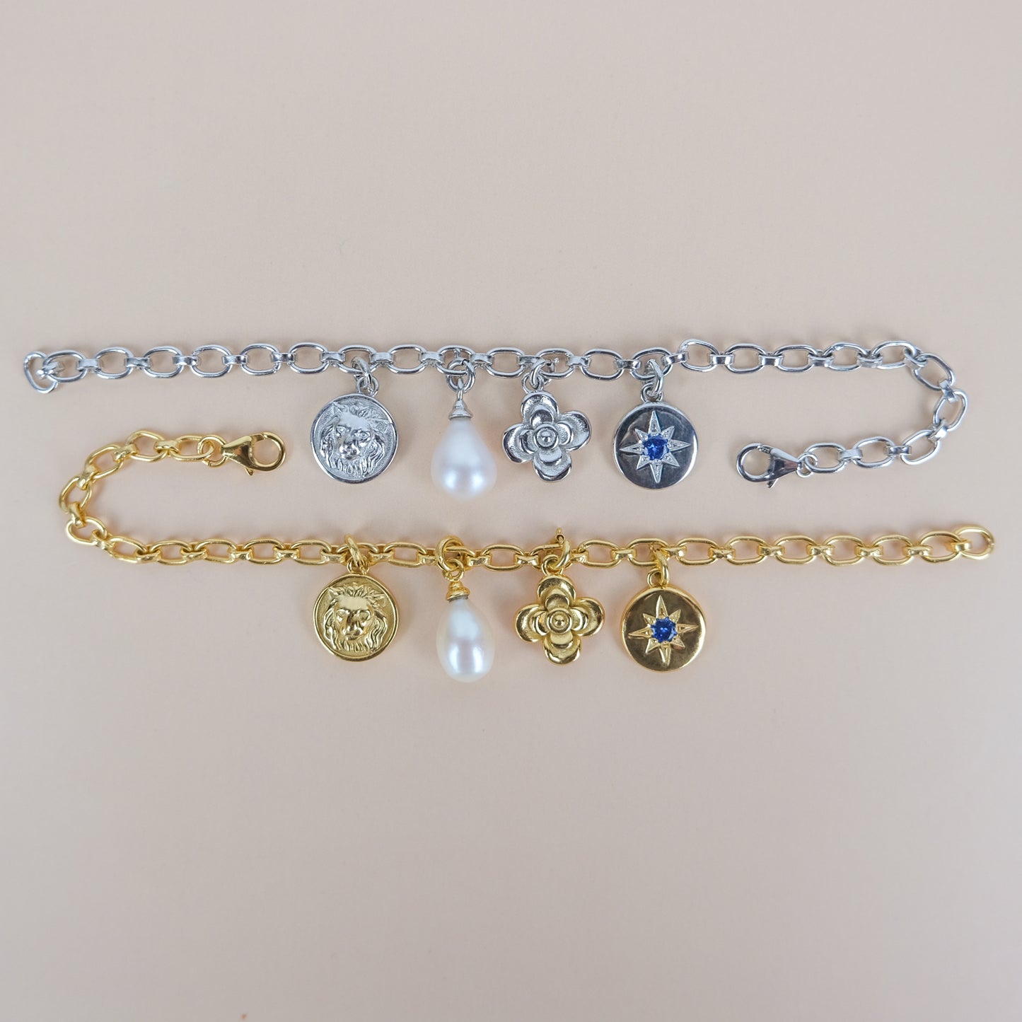 gold and sterling silver archivist bracelet with various charms on a beige background