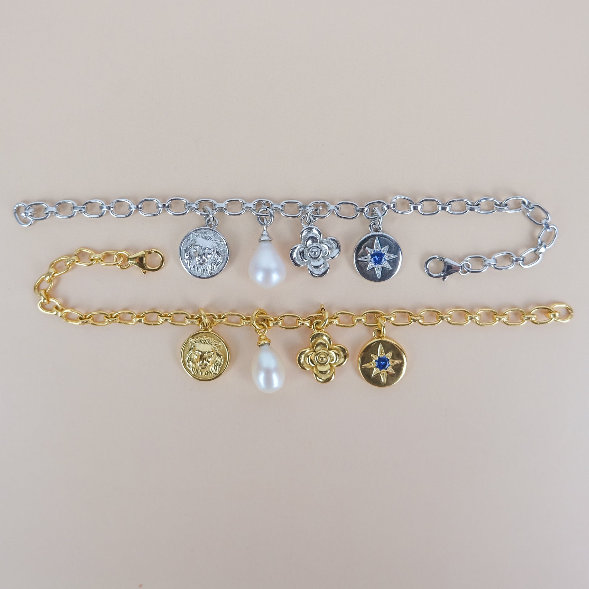 sterling silver and gold archivist bracelets with various charms on a beige background