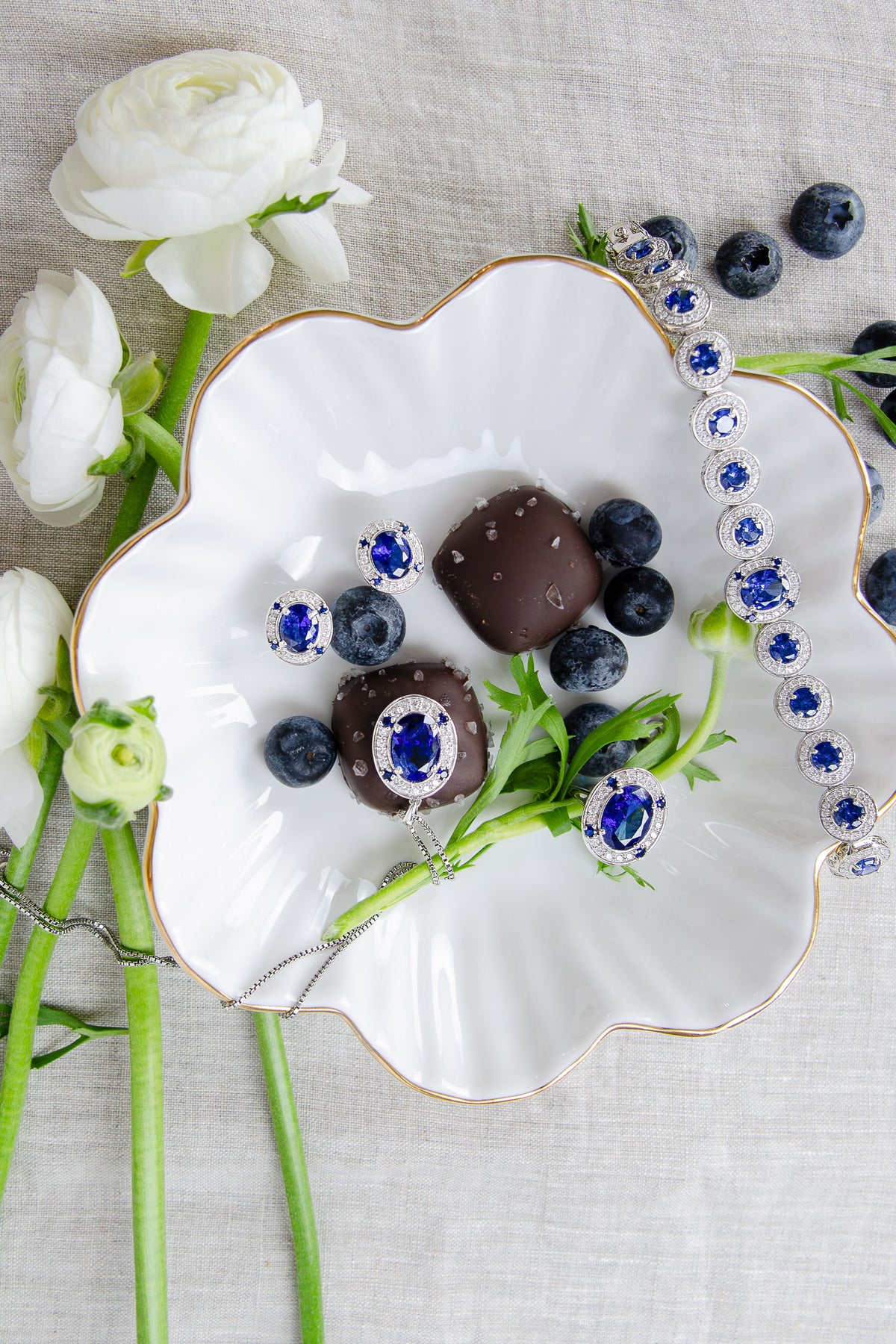 Styled group photo showcasing the complete Diana Legacy Collection, blending sapphire gemstones, and sterling silver to celebrate love, legacy, and light, Ether Jewelry