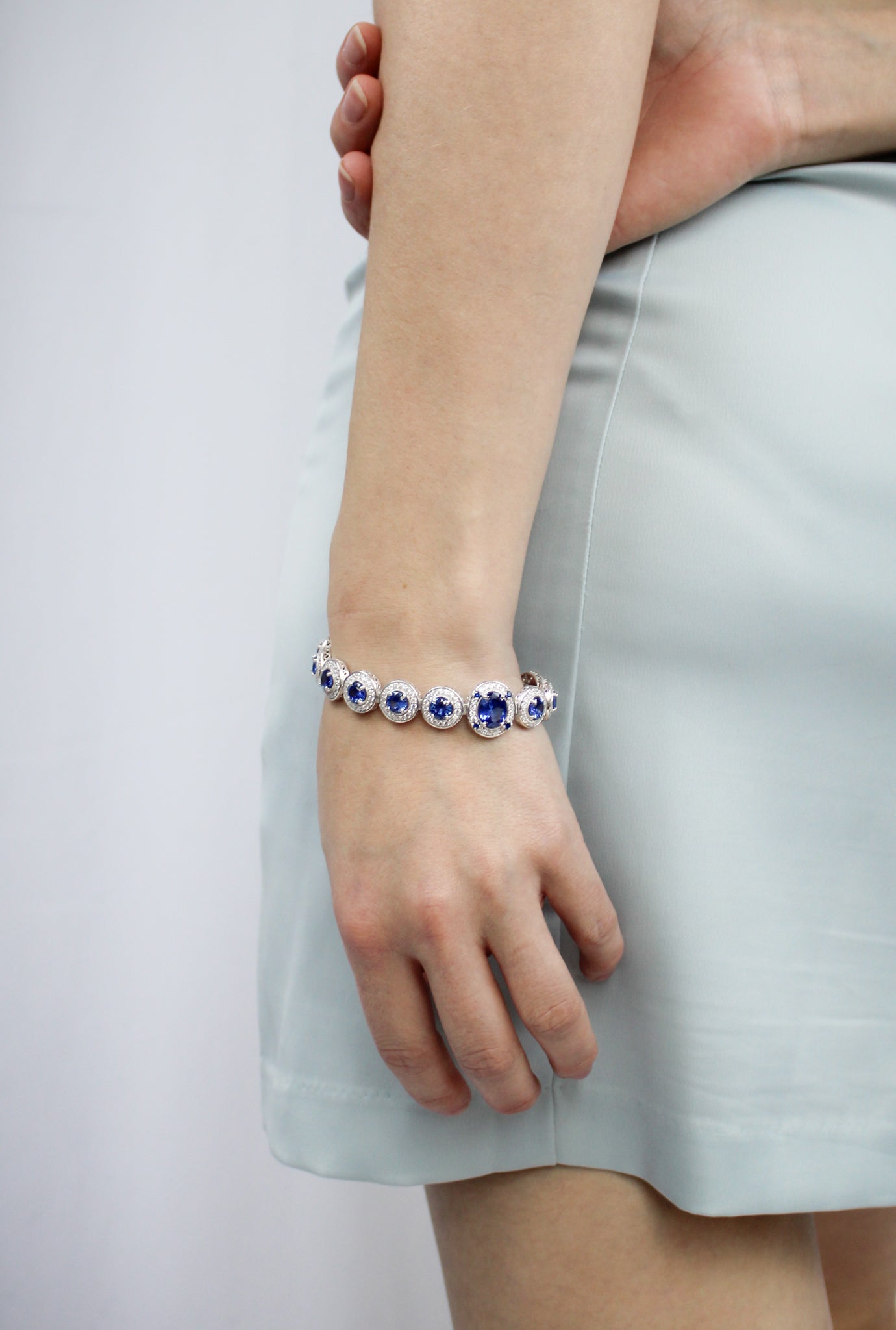 Model wearing silver Halo Bracelet with sapphire-toned gemstones — inspired by Princess Diana’s enduring legacy.