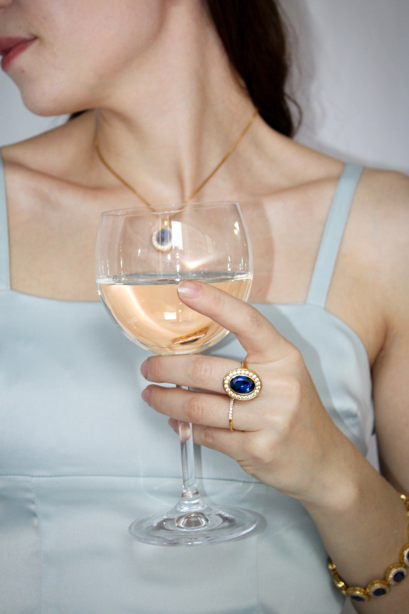 Model gently holding tea cup while wearing gold Legacy Ring, evoking Princess Diana’s elegance and quiet strength.