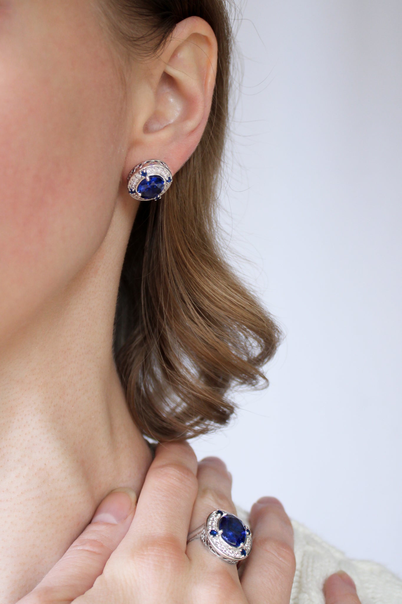 Model with loose waves wearing silver Sovereign Studs, evoking quiet confidence and beauty.