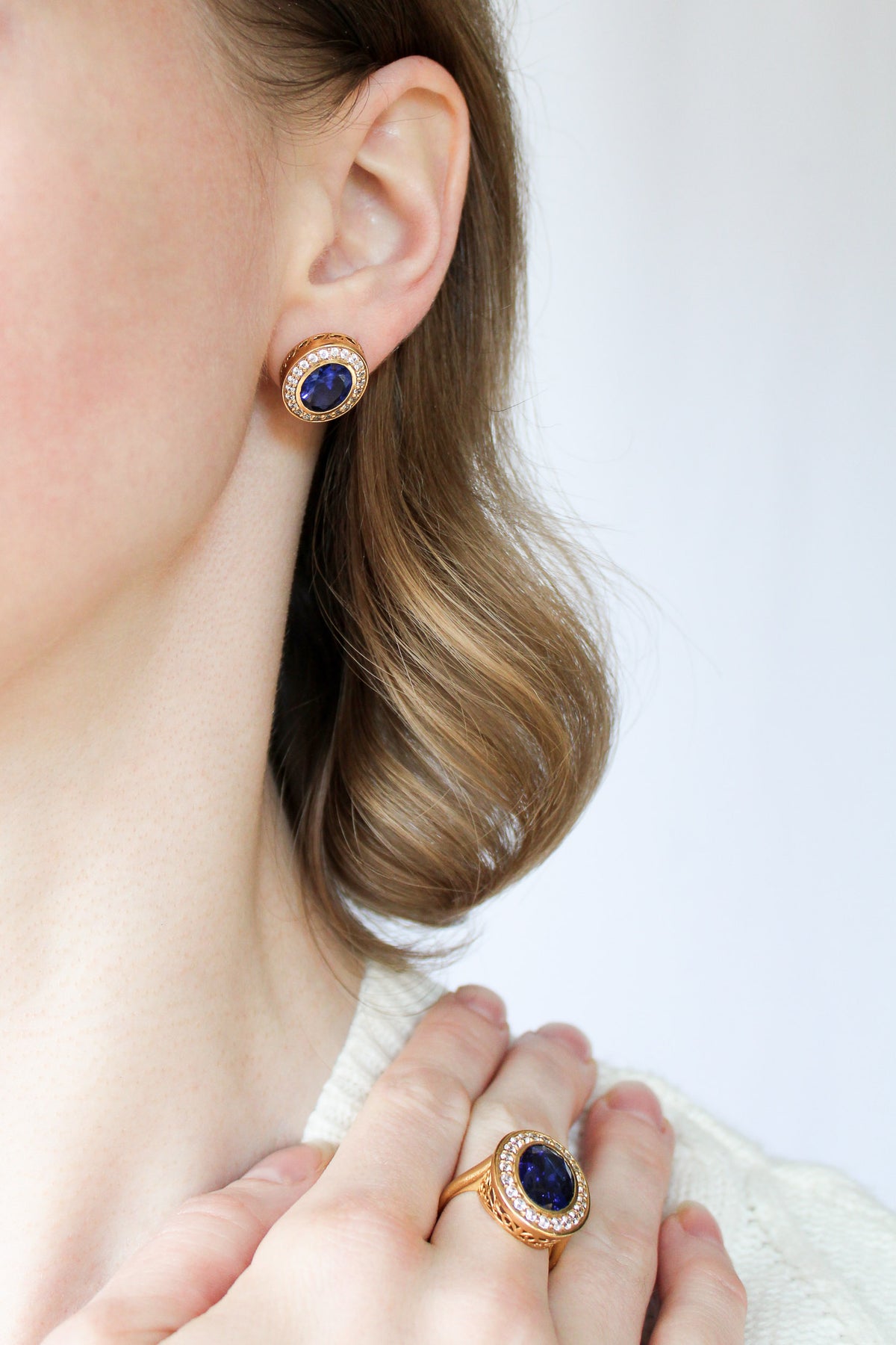 Profile shot of model wearing gold Sovereign Studs, luminous halos symbolizing modern royalty, Ether Jewelry
