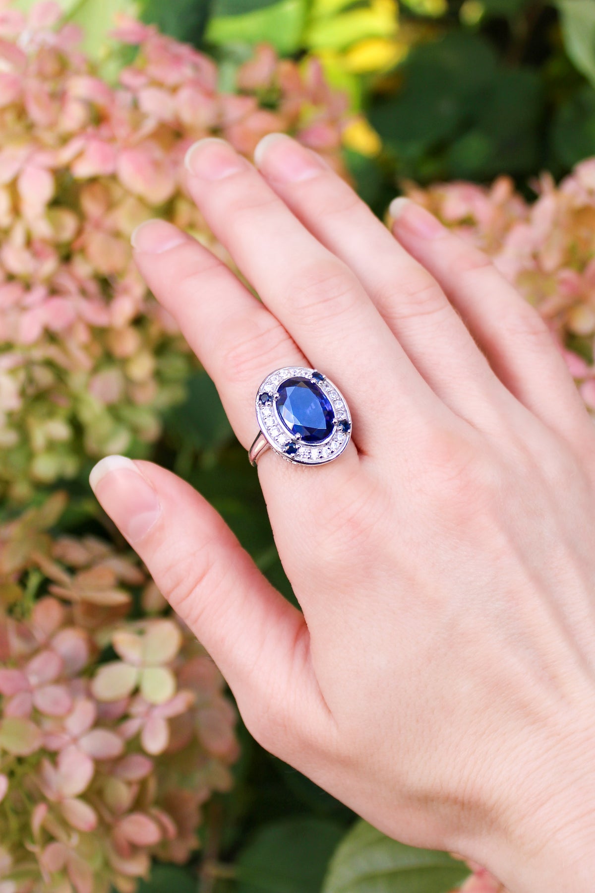 Model wearing The Legacy Ring in sterling silver, sapphire gemstone glimmering softly — timeless elegance inspired by Princess Diana, Ether Jewelry