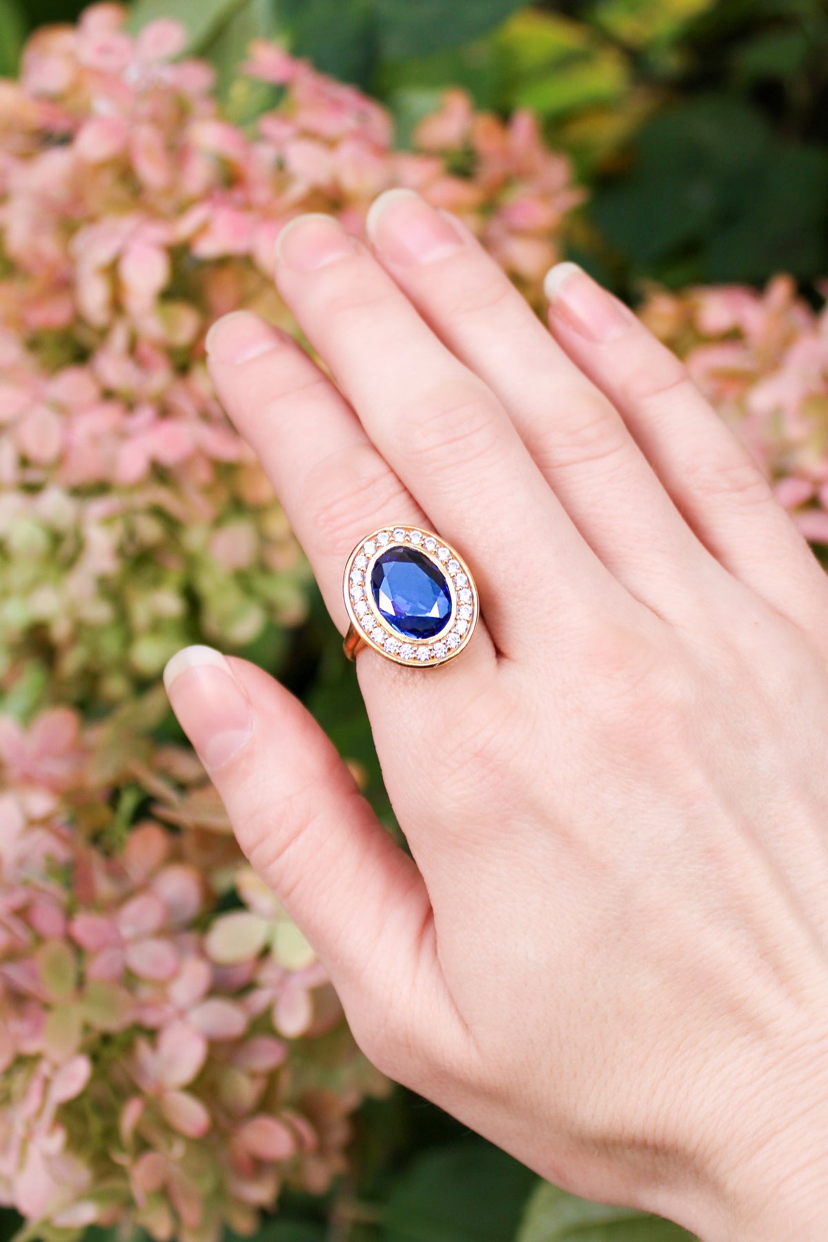 Detailed macro of gold Legacy Ring showing sapphire gem and luminous white stones in vintage-inspired setting, Ether Jewelry