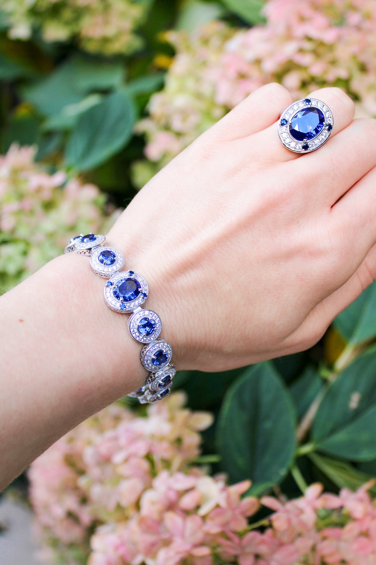 Close-up of silver Halo Bracelet resting on model’s wrist, luminous halos symbolizing renewal and grace, Ether Jewelry