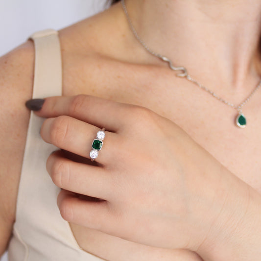 Edwardian Three Stone ring in sterling silver worn on model in beige dress, hand near chest, green CZ three stone ring, Ether Jewelry