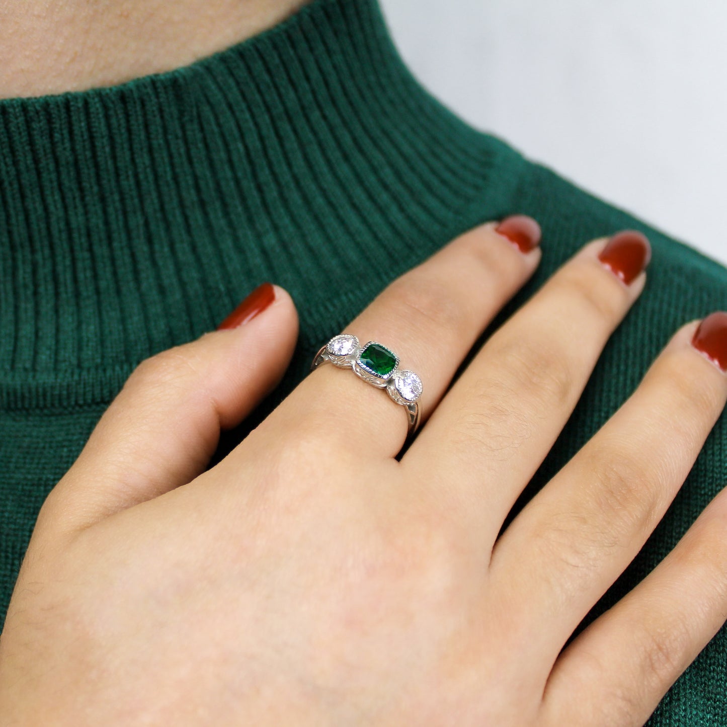 Edwardian Three Stone ring in sterling silver worn on model hand across shoulder, green CZ three stone milgrain ring, Ether Jewelry