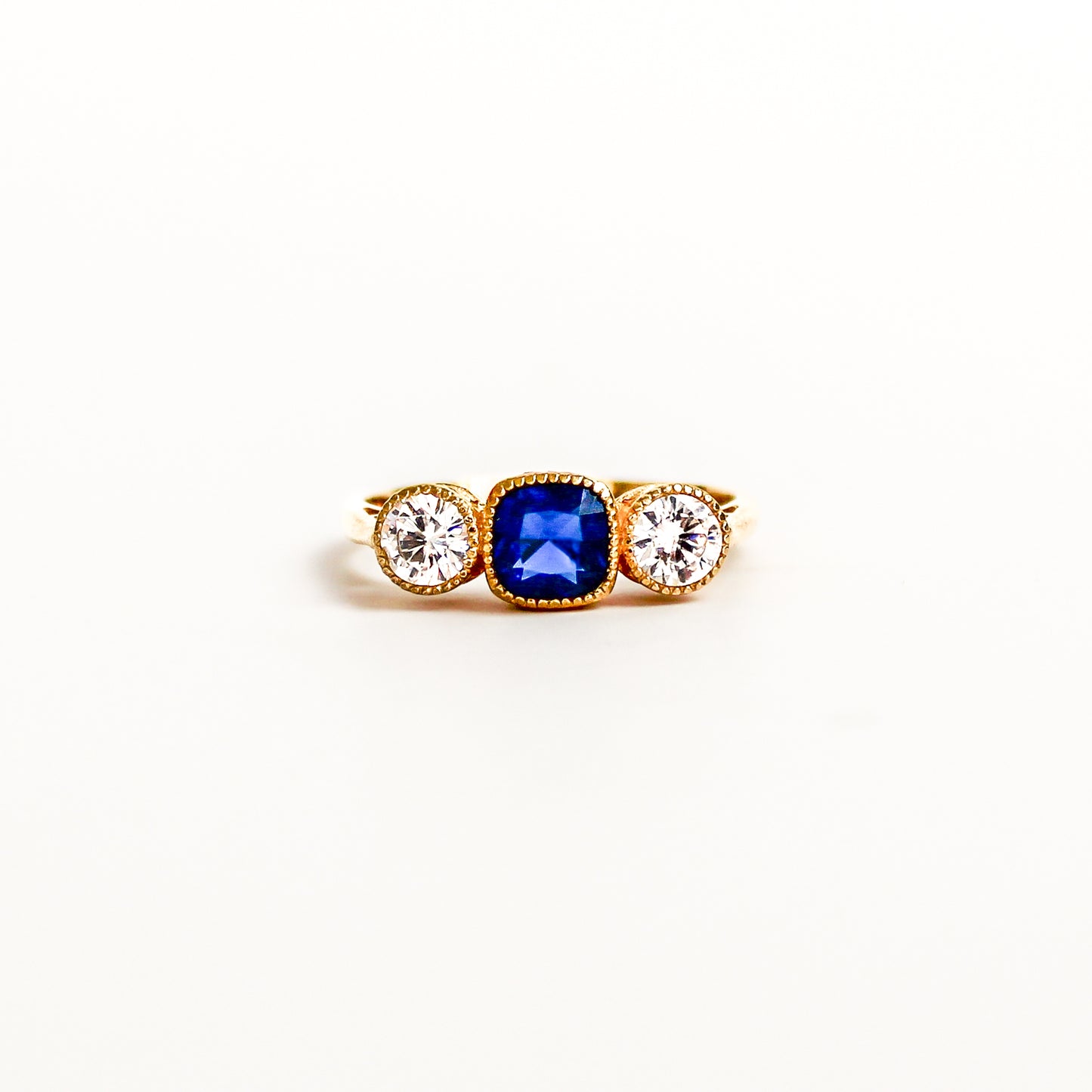 Edwardian Empress 18k gold vermeil on white background, center blue gemstone, diamond accents, ether jewelry