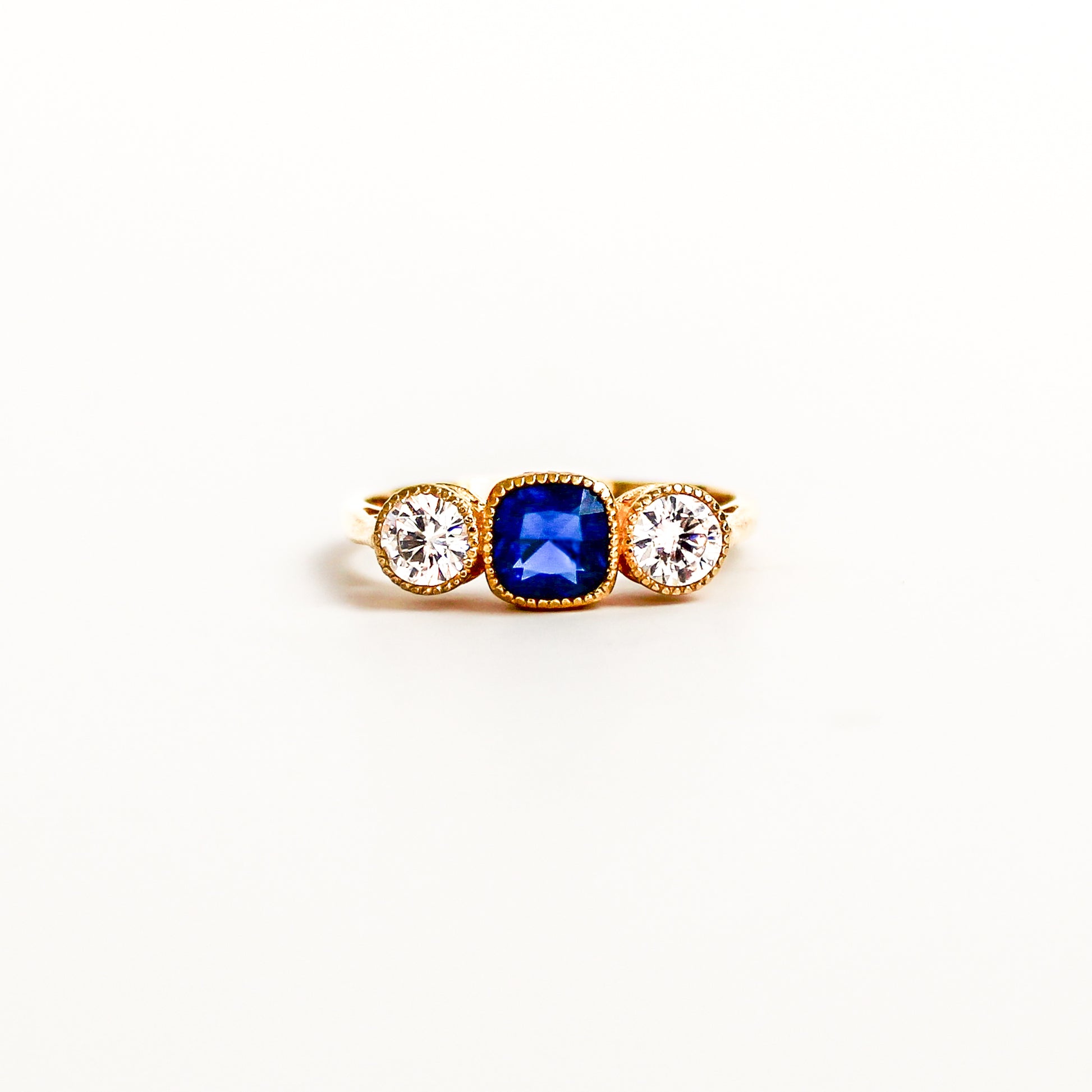 Edwardian Empress 18k gold vermeil on white background, center blue gemstone, diamond accents, ether jewelry
