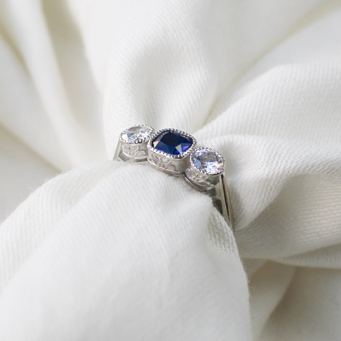 Edwardian Empress sterling silver ring wrapped around fabric showing filigree detail, blue CZ milgrain bezel ring, Ether Jewelry