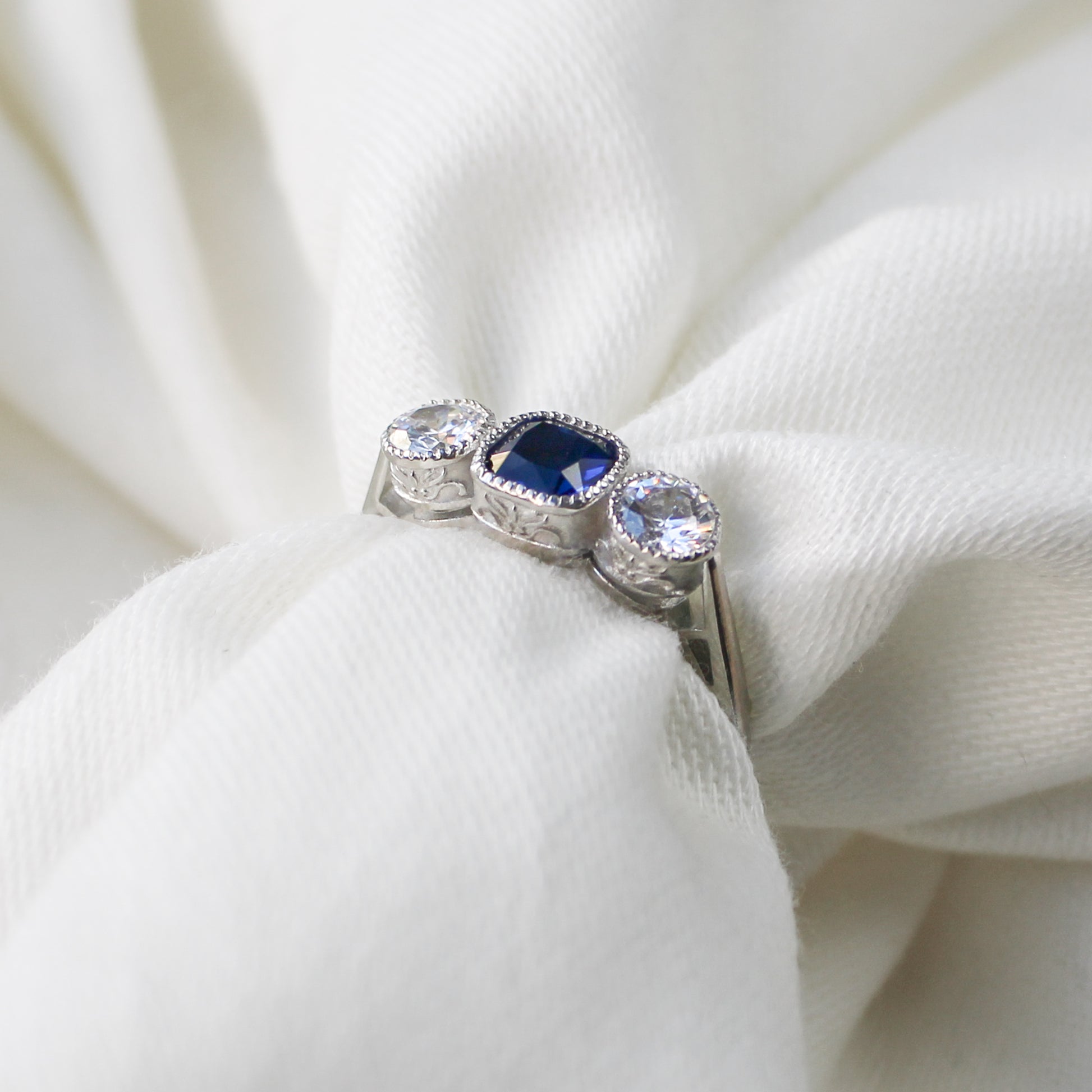 Edwardian Empress sterling silver ring wrapped around fabric showing filigree detail, blue CZ milgrain bezel ring, Ether Jewelry