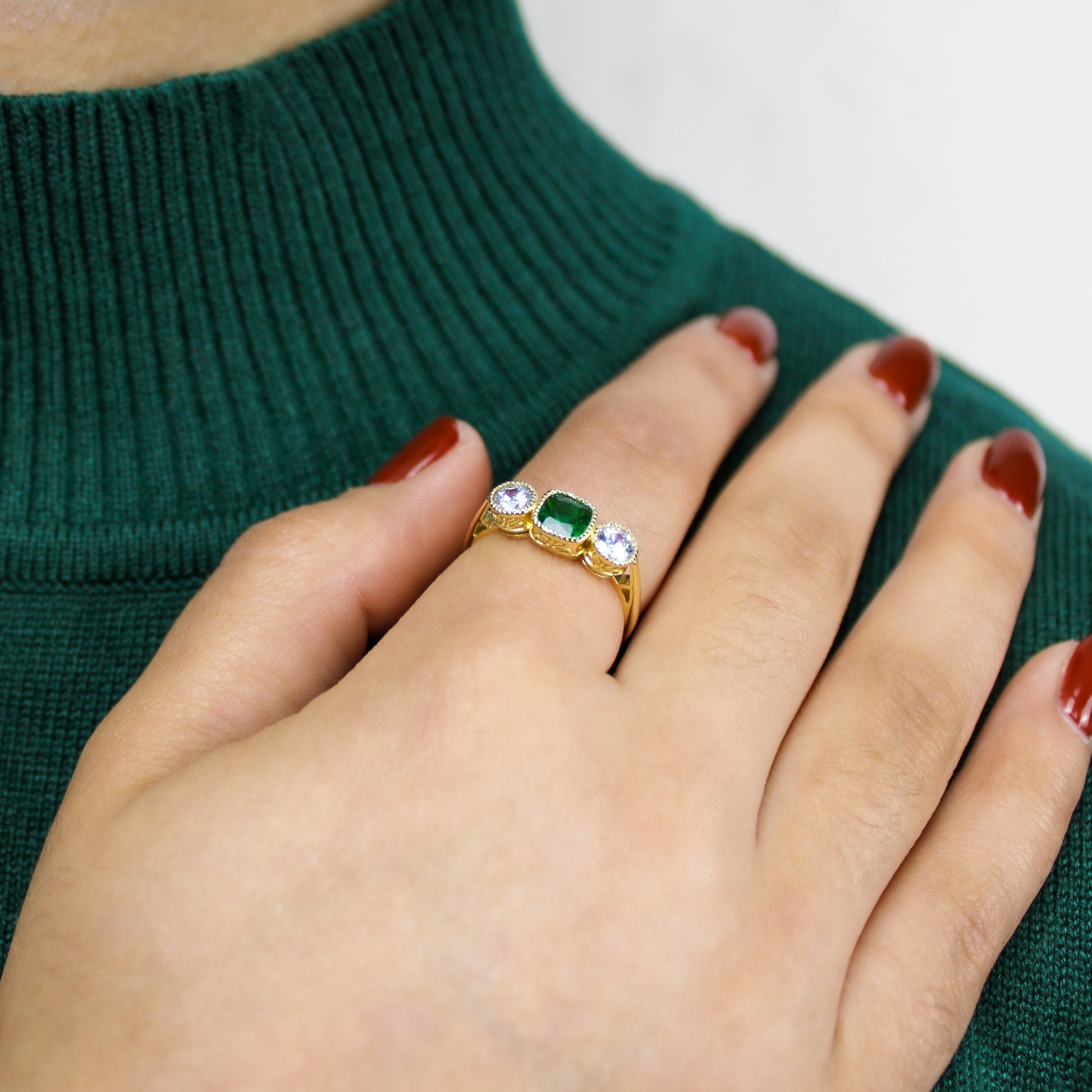 Edwardian Three Stone ring in 18k gold vermeil worn on model hand across shoulder, green CZ three stone milgrain ring, Ether Jewelry