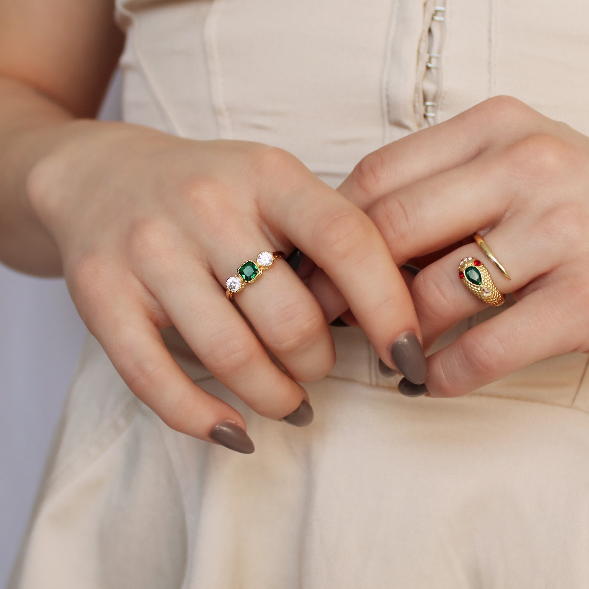 18k gold vermeil Edwardian Three Stone ring paired with queen victoria ring on model hands at stomach in beige dress, Ether Jewelry