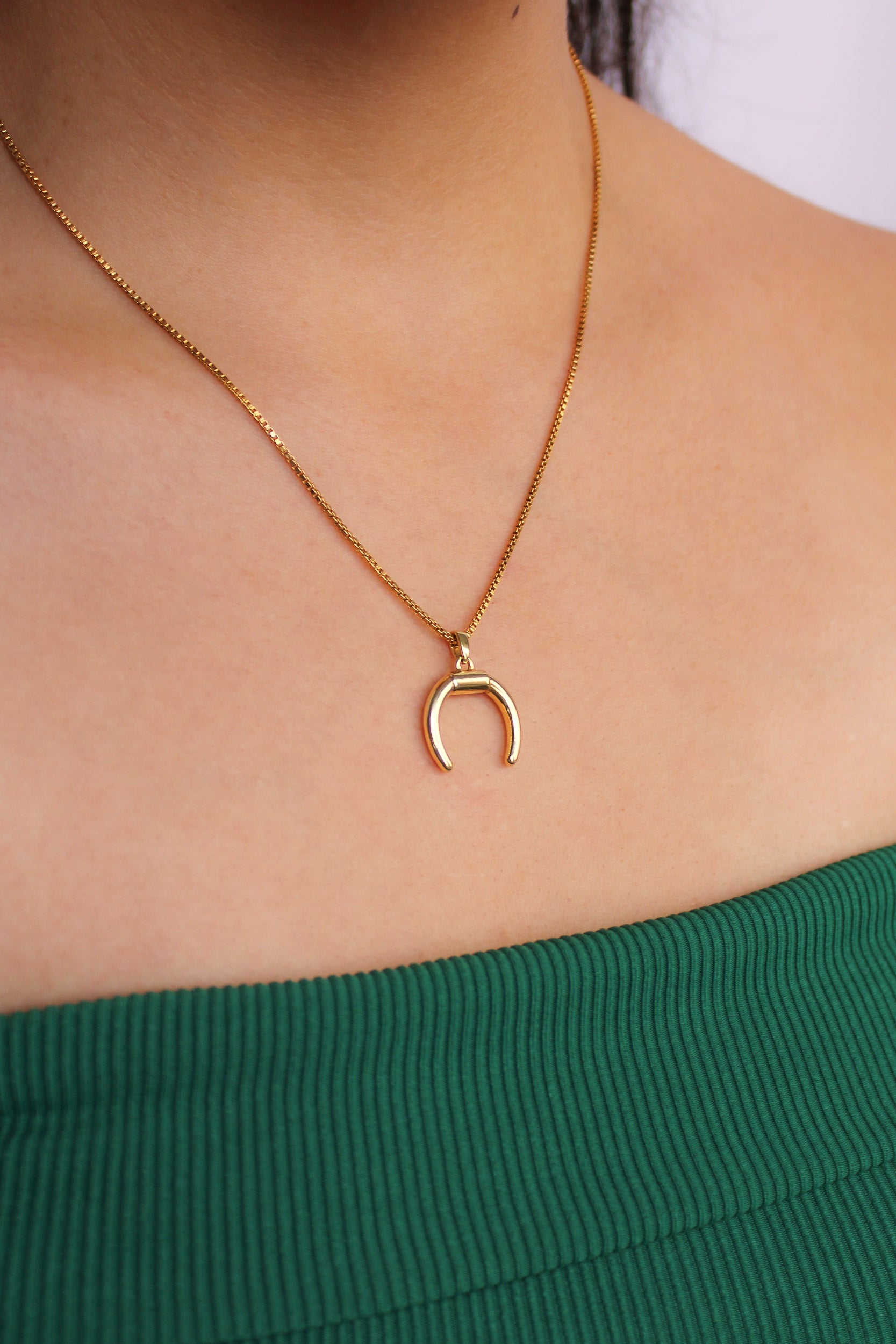 Ether Necklace in 18k gold vermeil worn by model, double horn crescent pendant close-up, Ether Jewelry