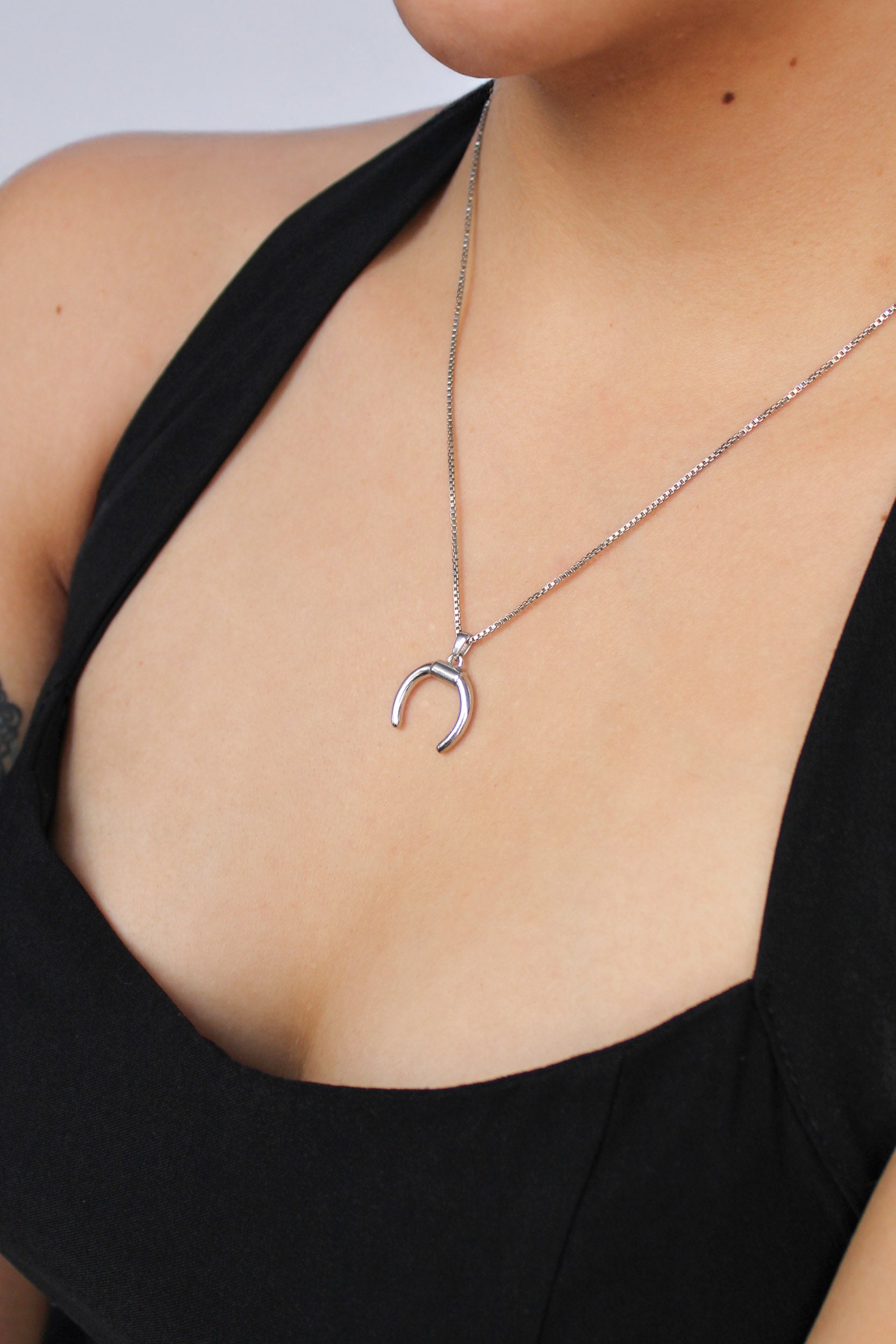 Ether Necklace in sterling silver worn by model, moon crescent pendant close-up, Ether Jewelry