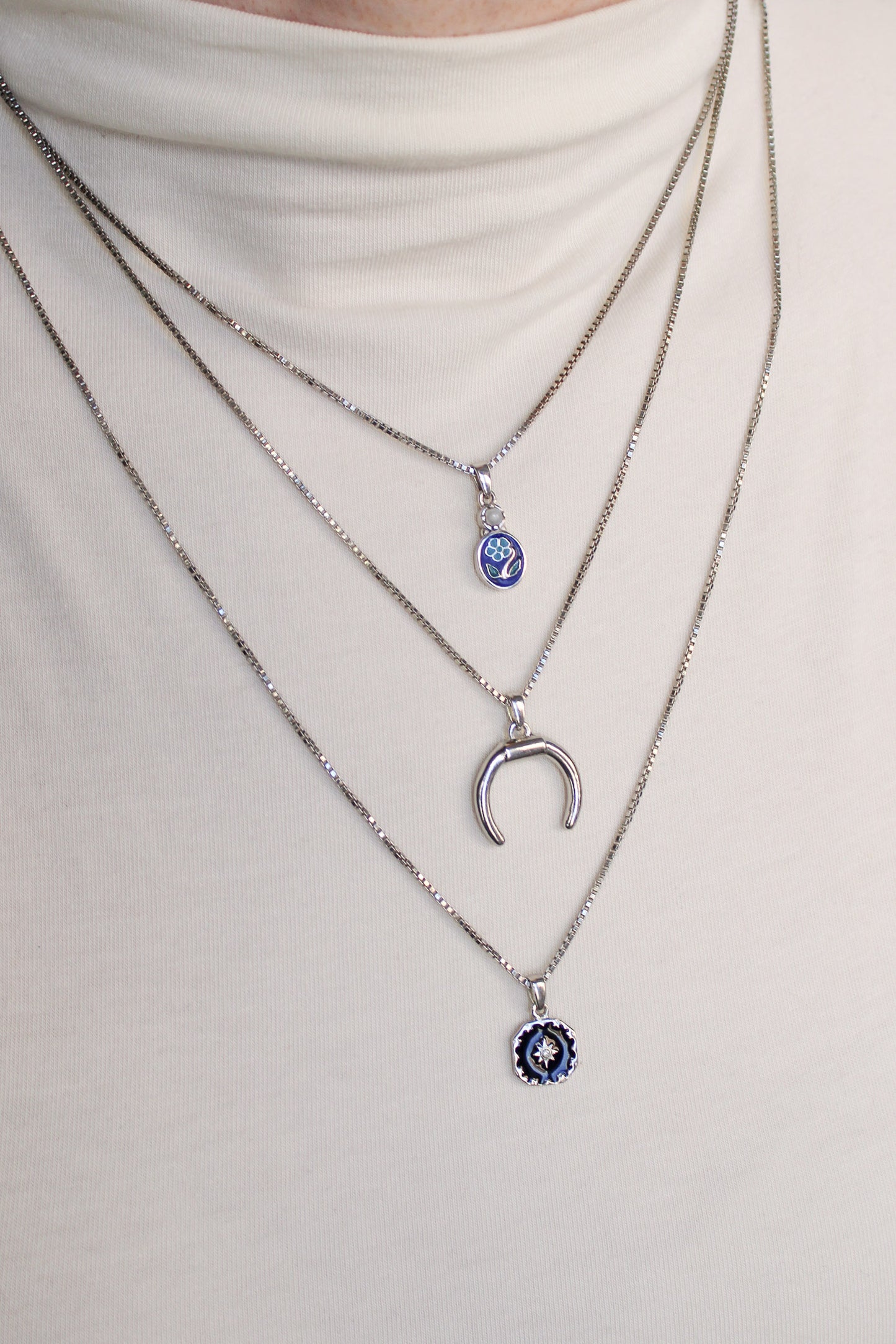 Ether Necklace in sterling silver layered with different length necklaces on model, Ether Jewelry