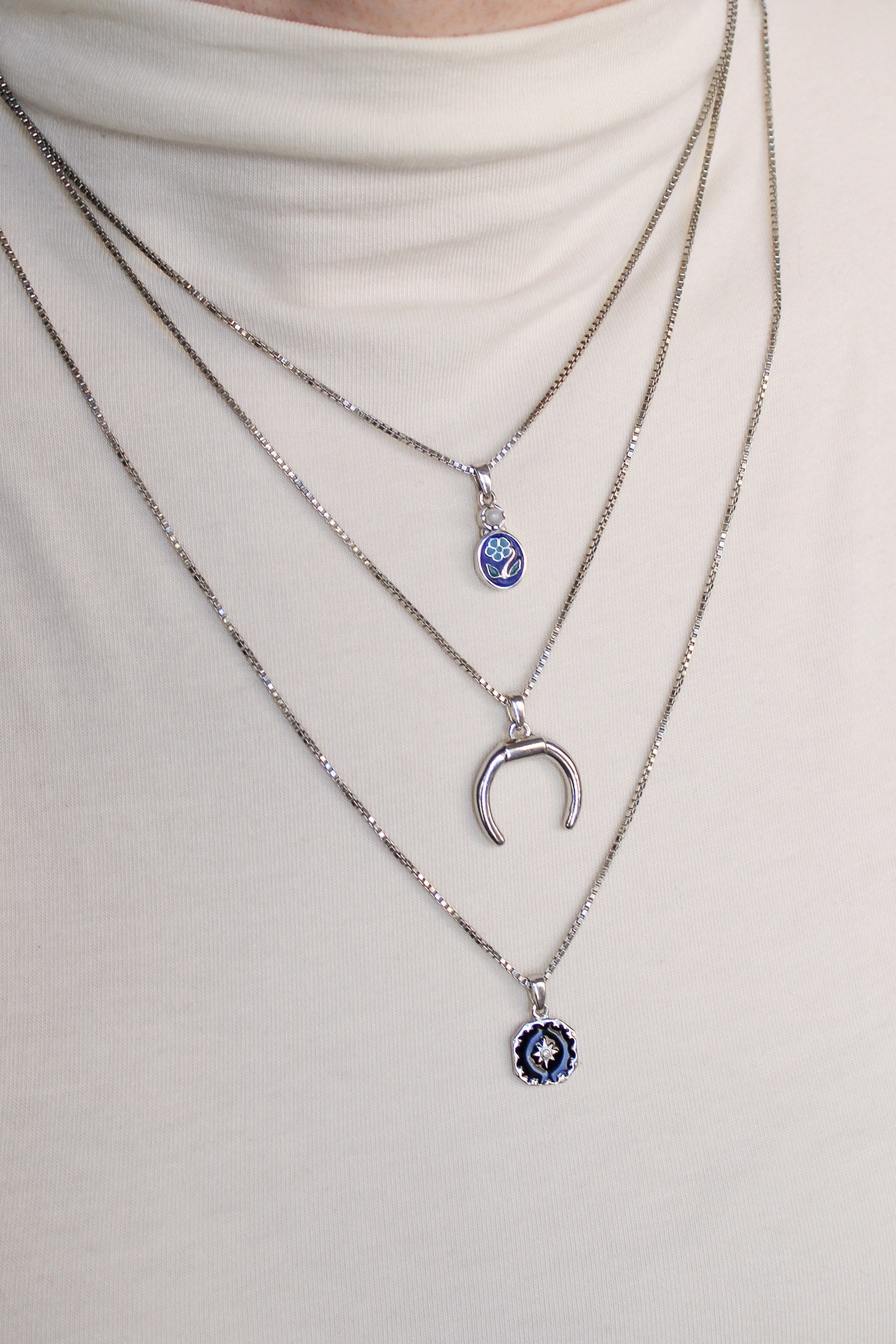 Ether Necklace in sterling silver layered with different length necklaces on model, Ether Jewelry