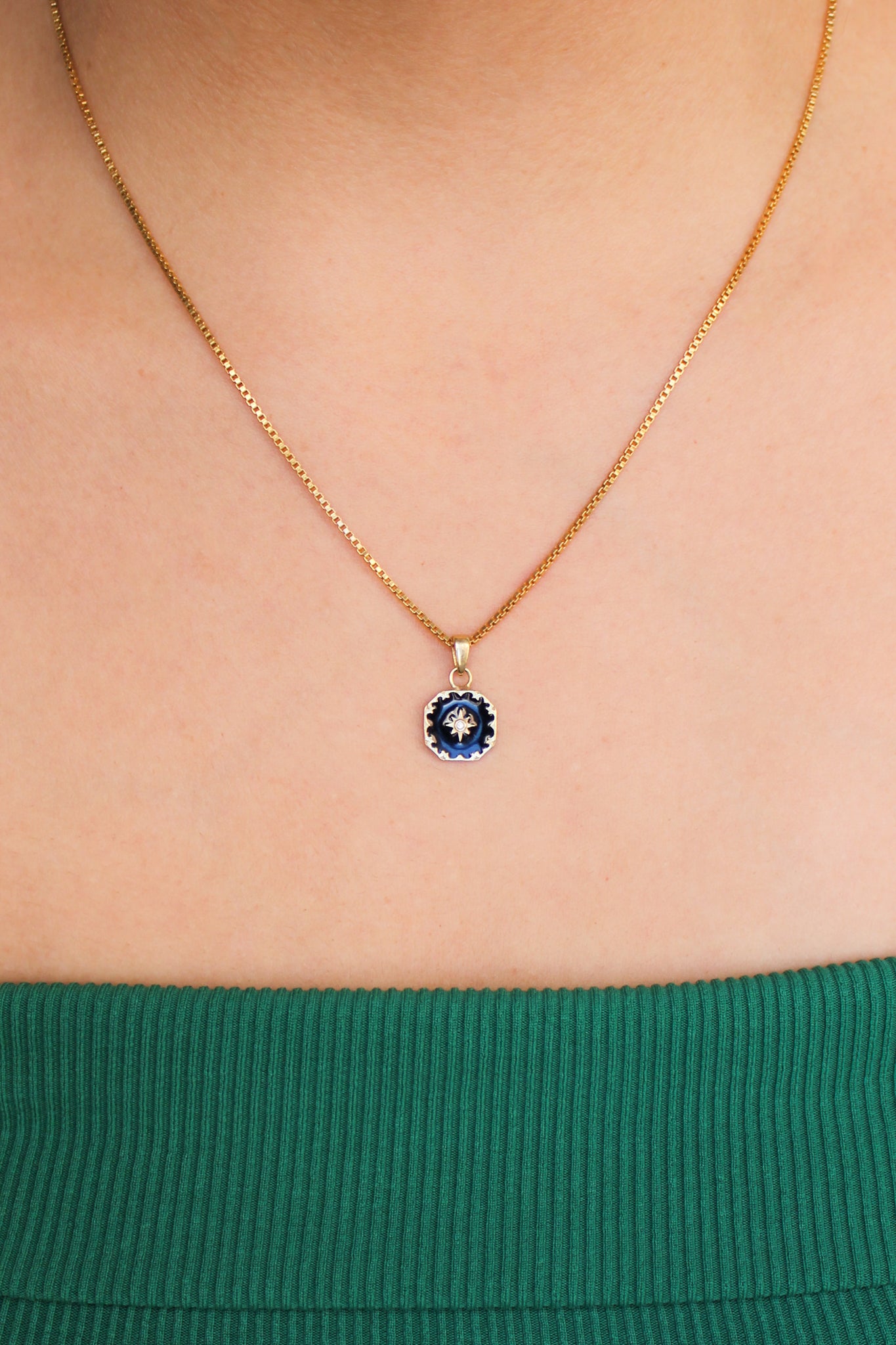 Nocturne Necklace in 18k gold vermeil worn on model, black enamel octagonal pendant with star-set CZ, front view, Ether Jewelry