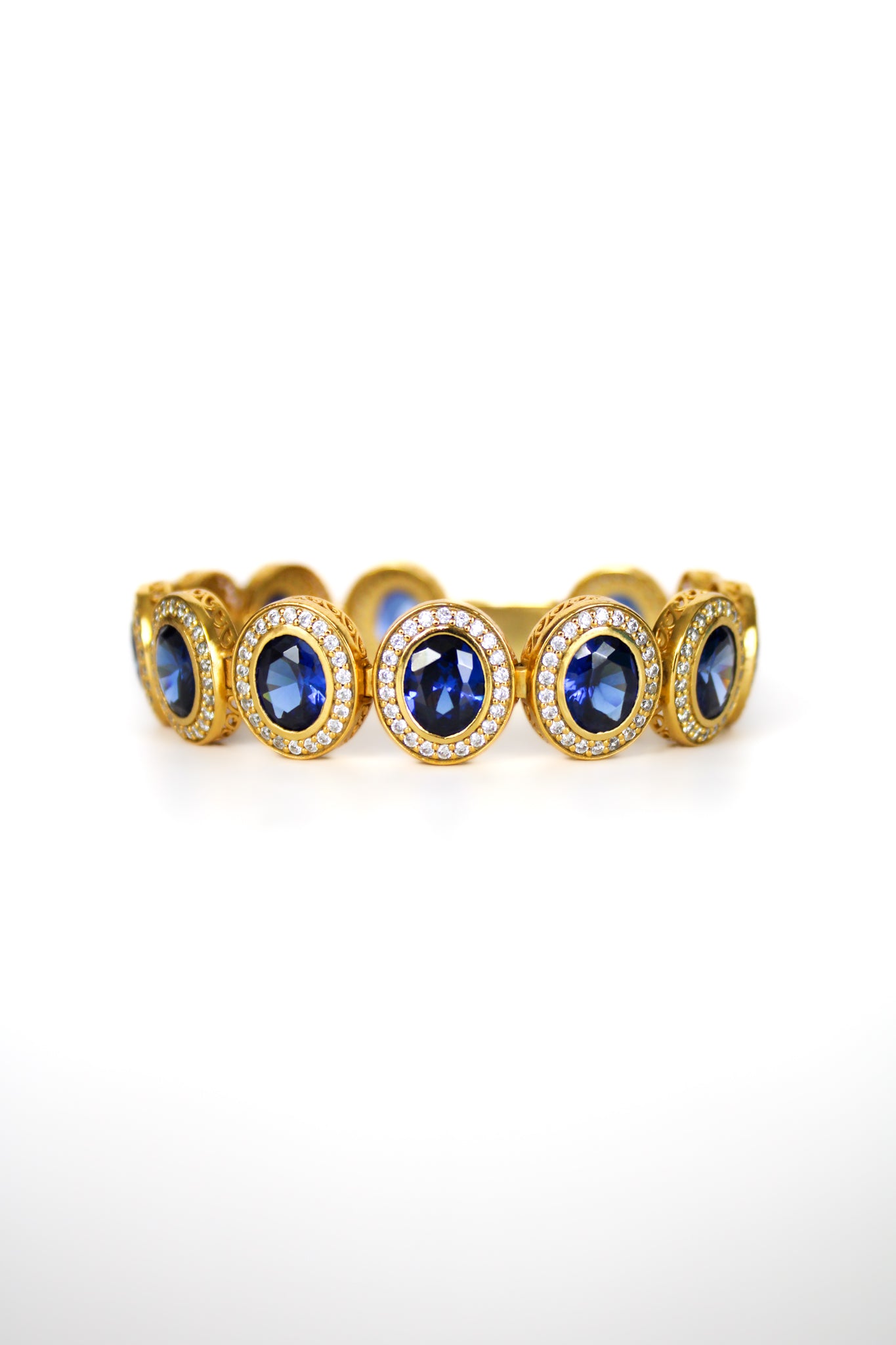 Gold Halo Bracelet with sapphire-toned and white gemstones forming radiant stations inspired by Princess Diana.