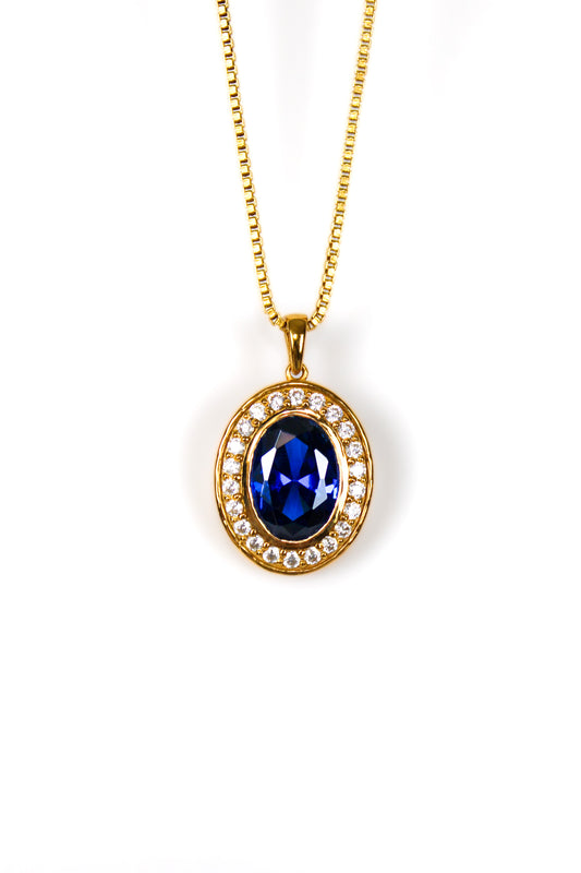 Gold Heartline Necklace with sapphire-toned gemstone and brilliant white accents inspired by Princess Diana’s elegance.