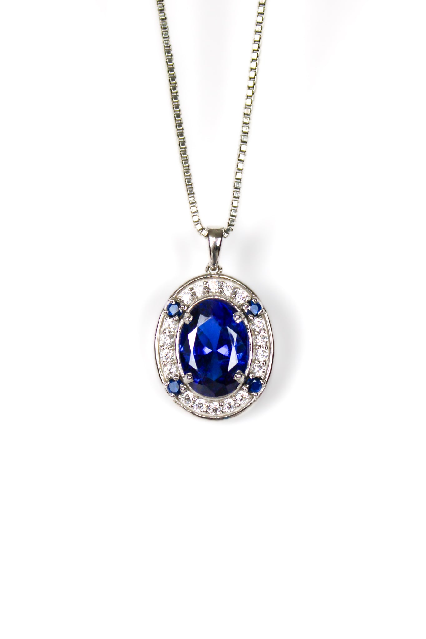 Sterling silver Heartline Necklace with sapphire-toned center gemstone and delicate white accents.