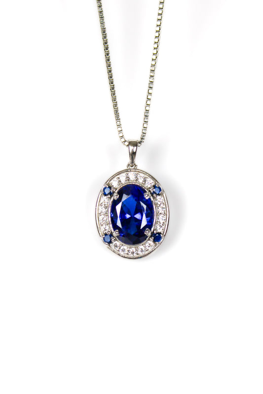Sterling silver Heartline Necklace with sapphire-toned center gemstone and delicate white accents.