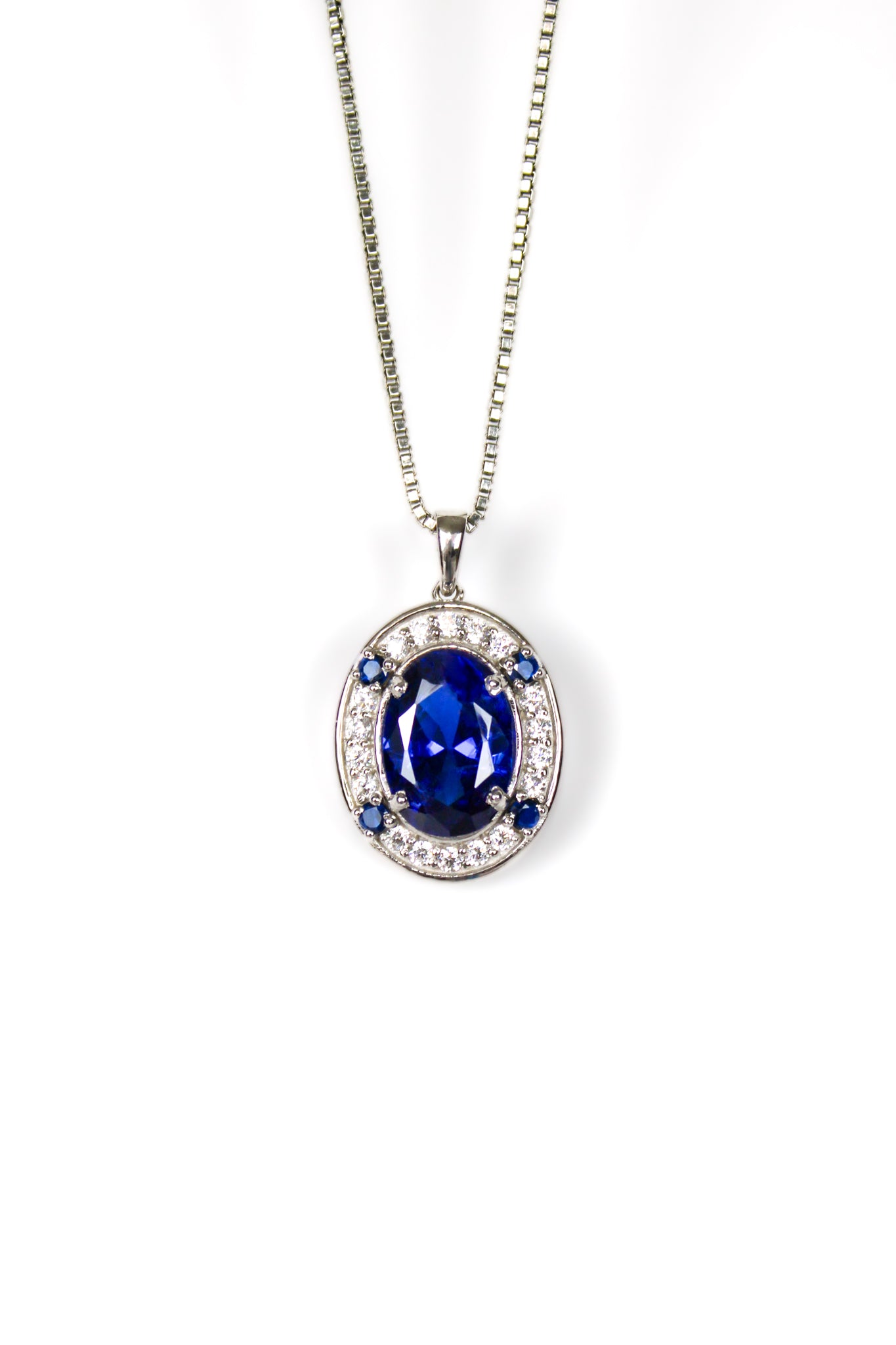 Sterling silver Heartline Necklace with sapphire-toned center gemstone and delicate white accents.