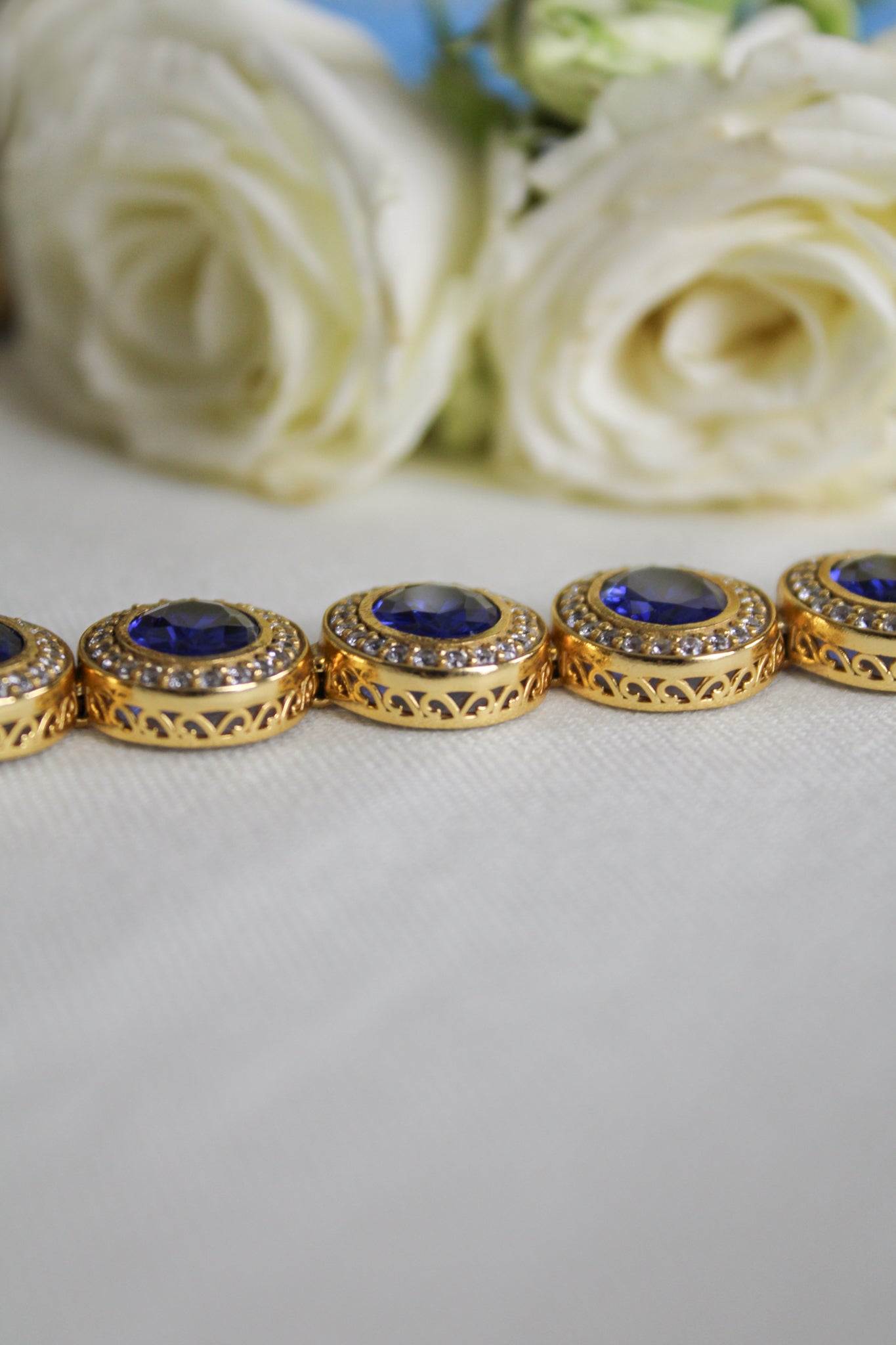 18k gold vermeil Halo Bracelet with luminous sapphire gemstones representing grace and light.
