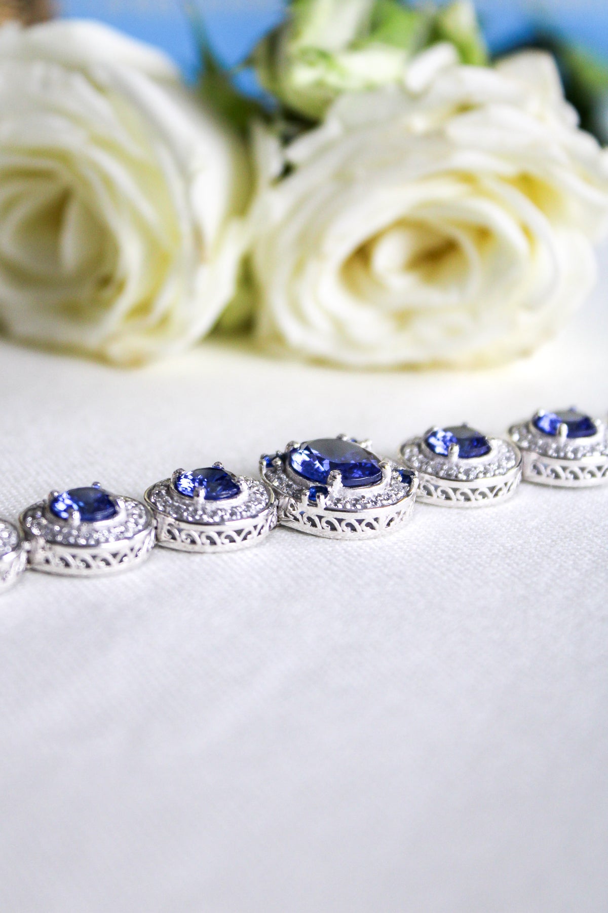 Silver Halo Bracelet by Ether Jewelry with sapphire and white stones reflecting elegance and remembrance, Ether Jewelry