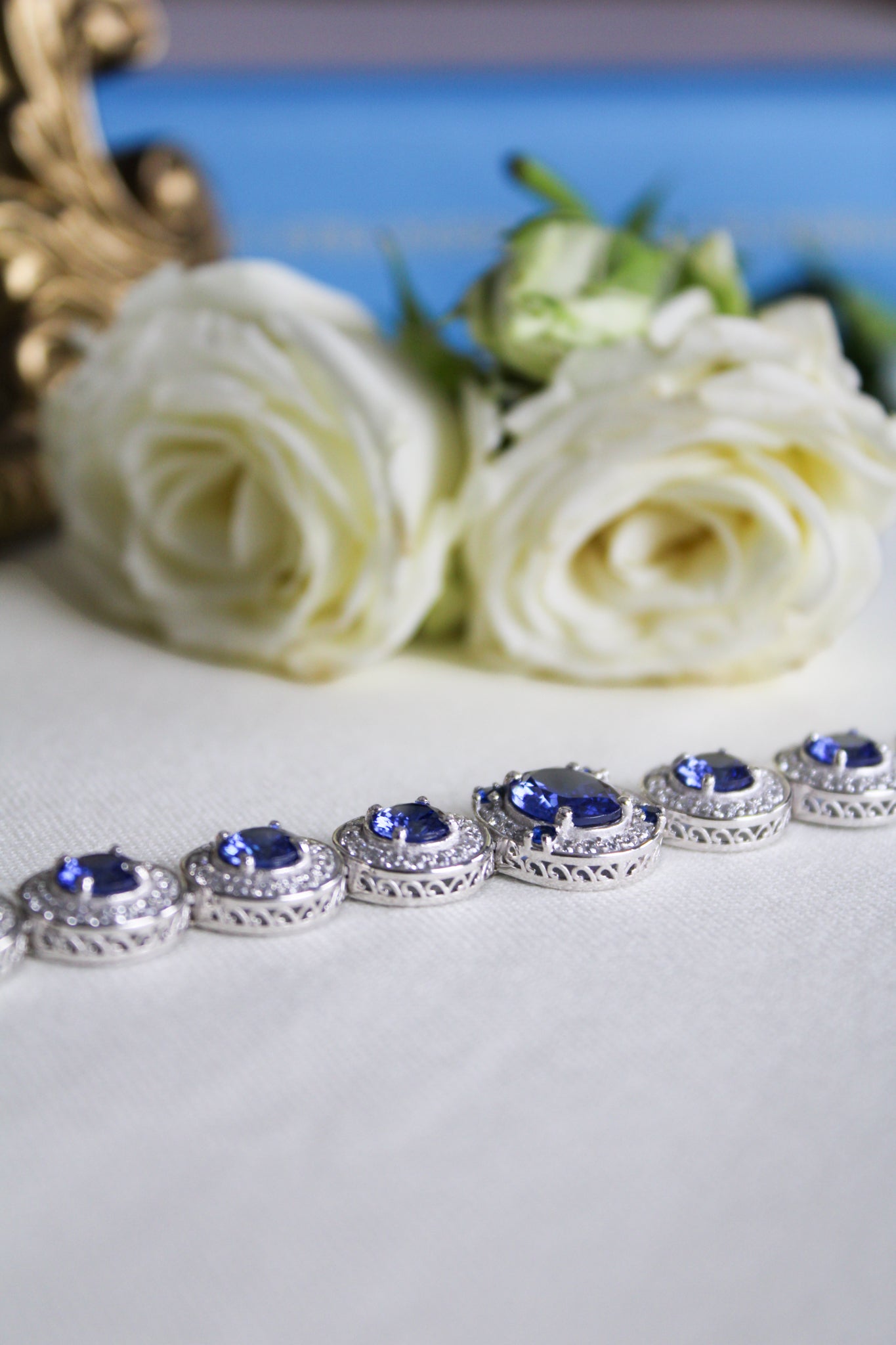 Silver Halo Bracelet by Ether Jewelry with sapphire and white stones reflecting elegance and remembrance.