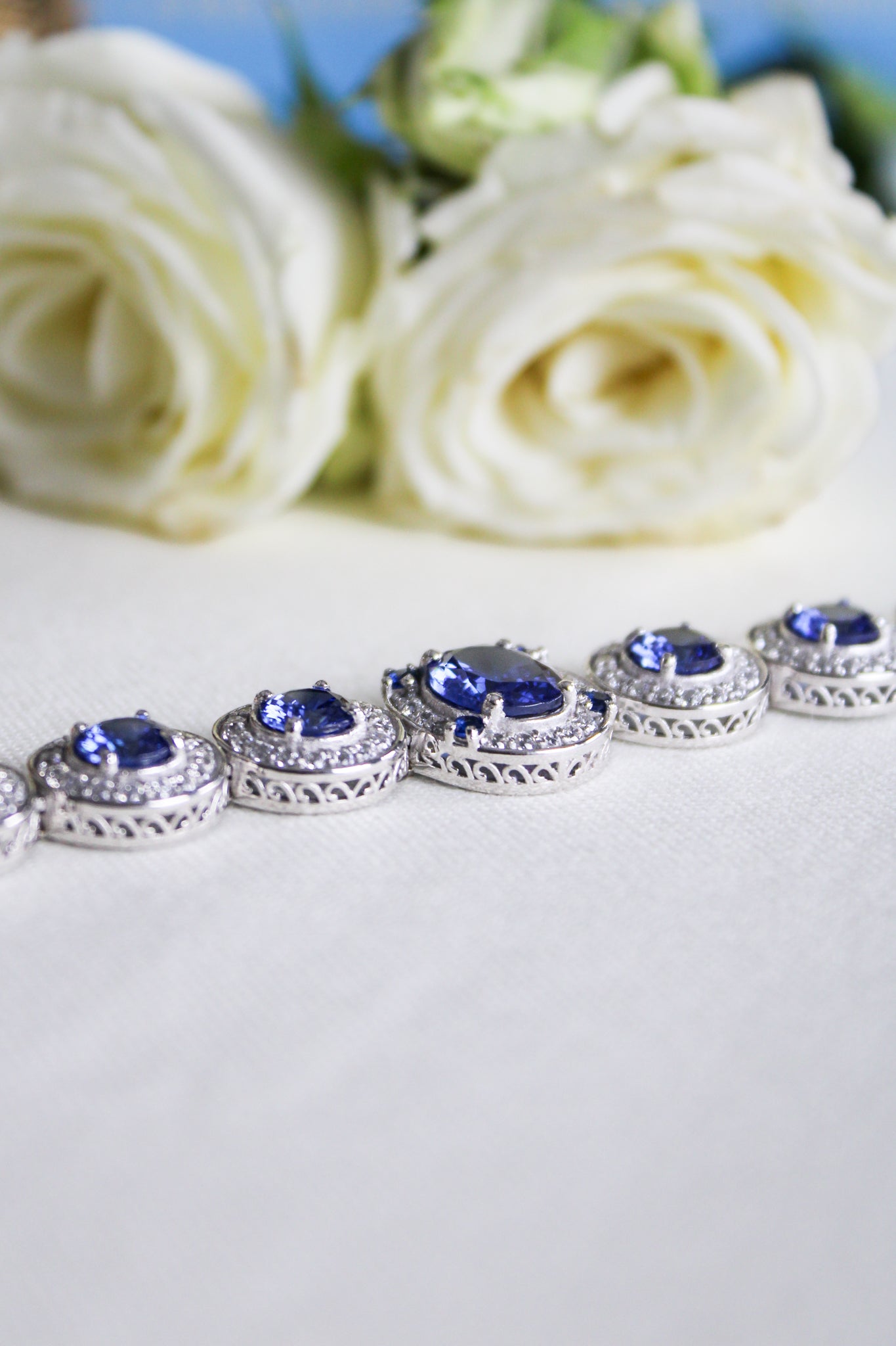 Silver Halo Bracelet by Ether Jewelry with sapphire and white stones reflecting elegance and remembrance, Ether Jewelry