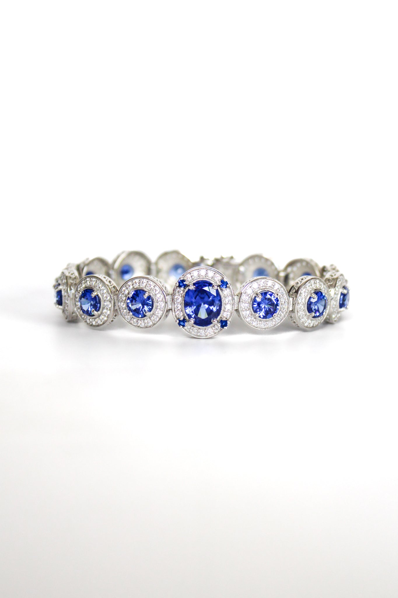 Sterling silver Halo Bracelet featuring sapphire-toned gemstones surrounded by white halos inspired by Diana.