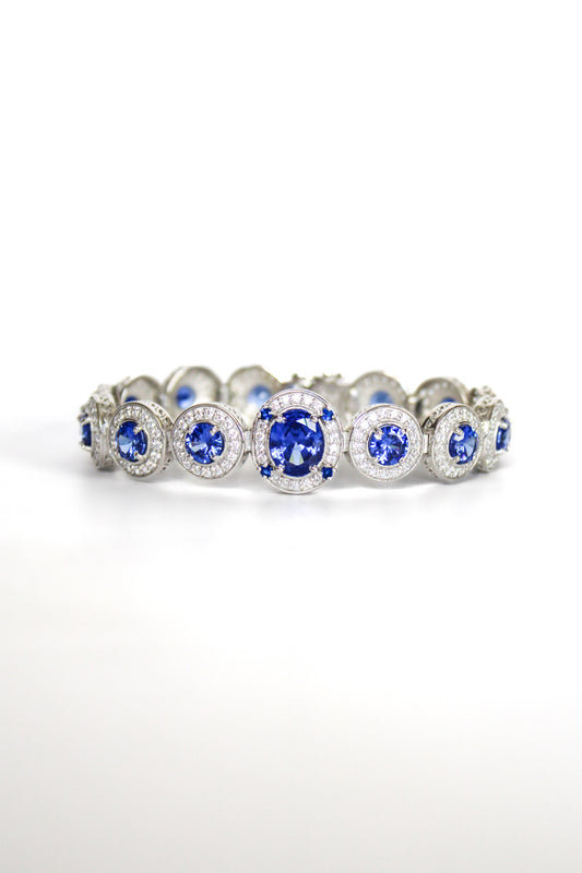 Sterling silver Halo Bracelet featuring sapphire-toned gemstones surrounded by white halos inspired by Diana.