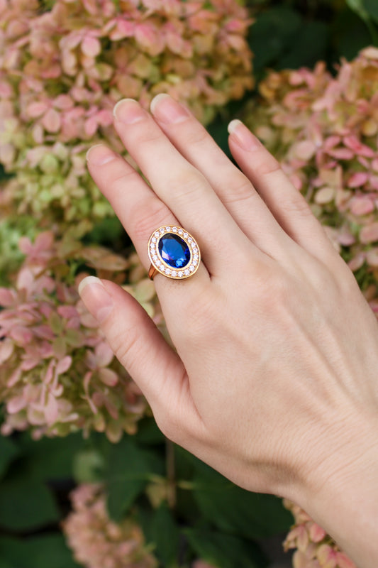 Detailed macro of gold Legacy Ring showing sapphire gem and luminous white stones in vintage-inspired setting, Ether Jewelry