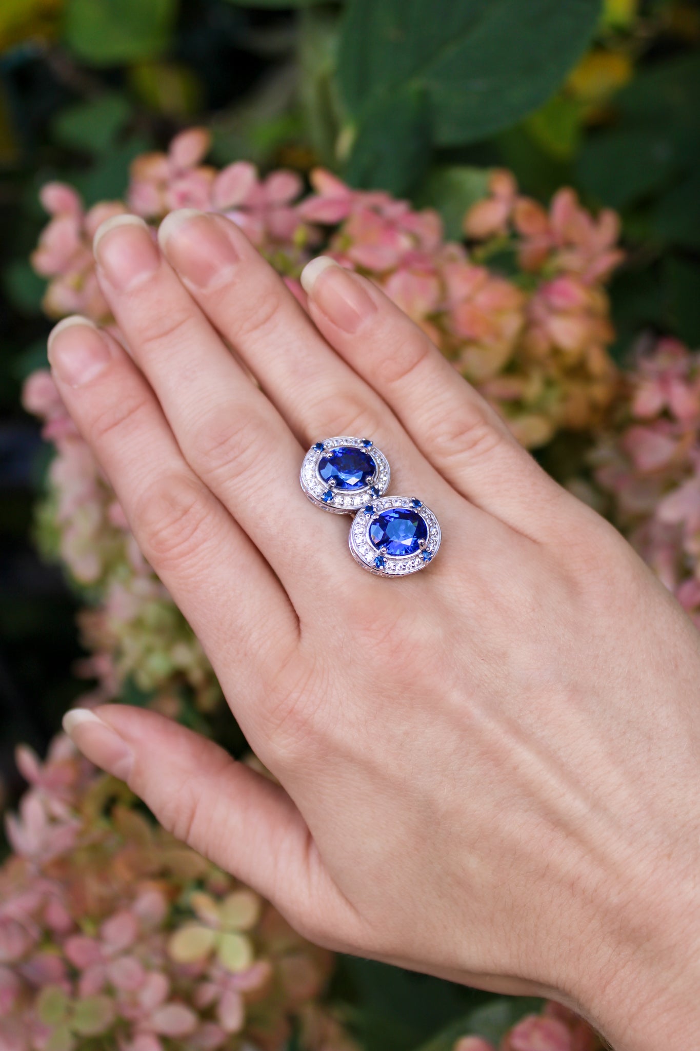 Pair of silver Sovereign Stud Earrings with sapphire center stones symbolizing grace and strength.