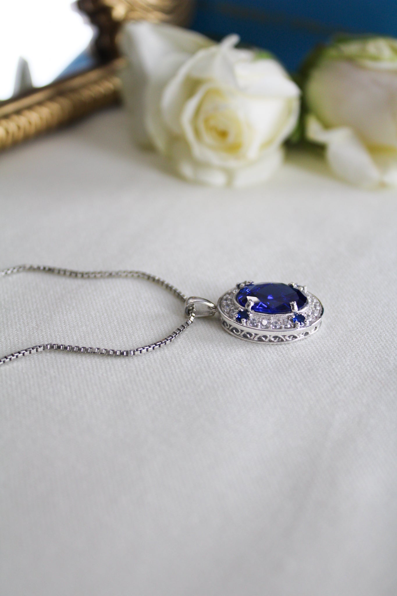 Close-up of silver Heartline Necklace inspired by Princess Diana’s iconic sapphire jewelry.
