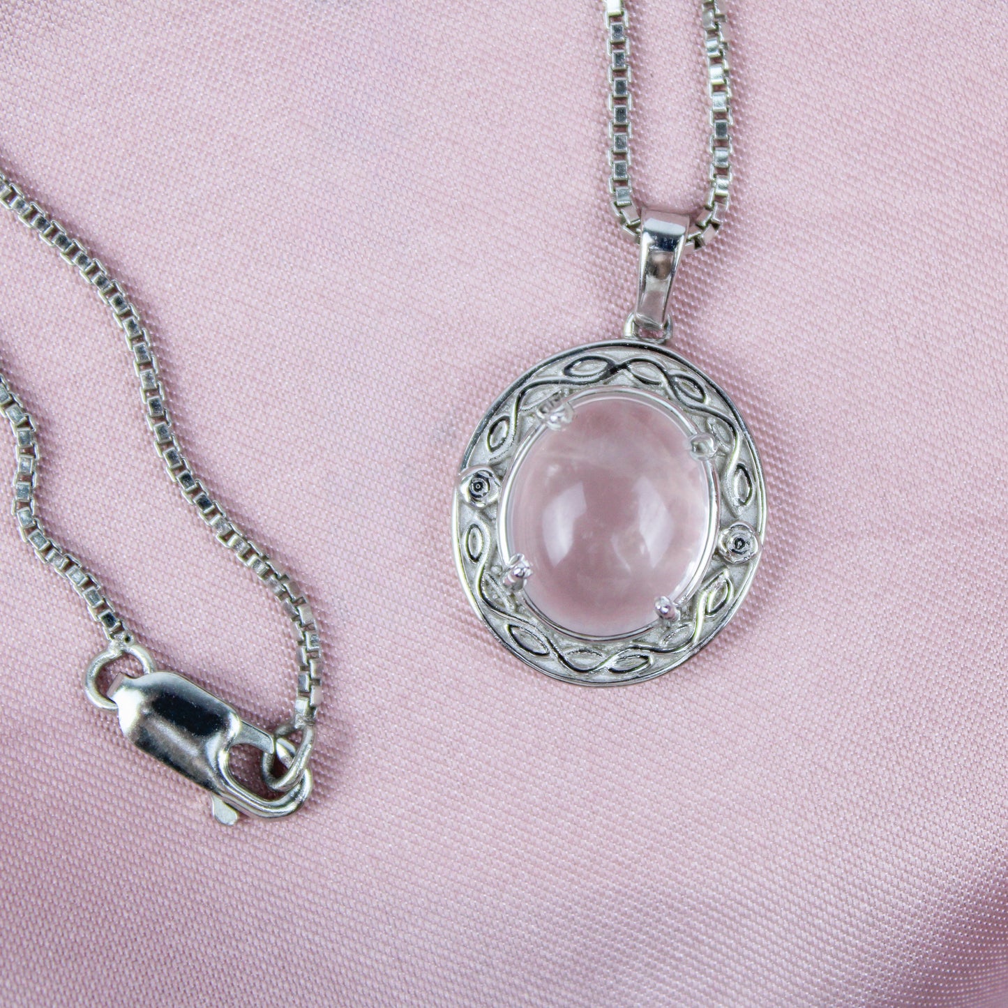 Sterling Silver Romantic Heir  pendant with a pink quartz gemstone on a pink background